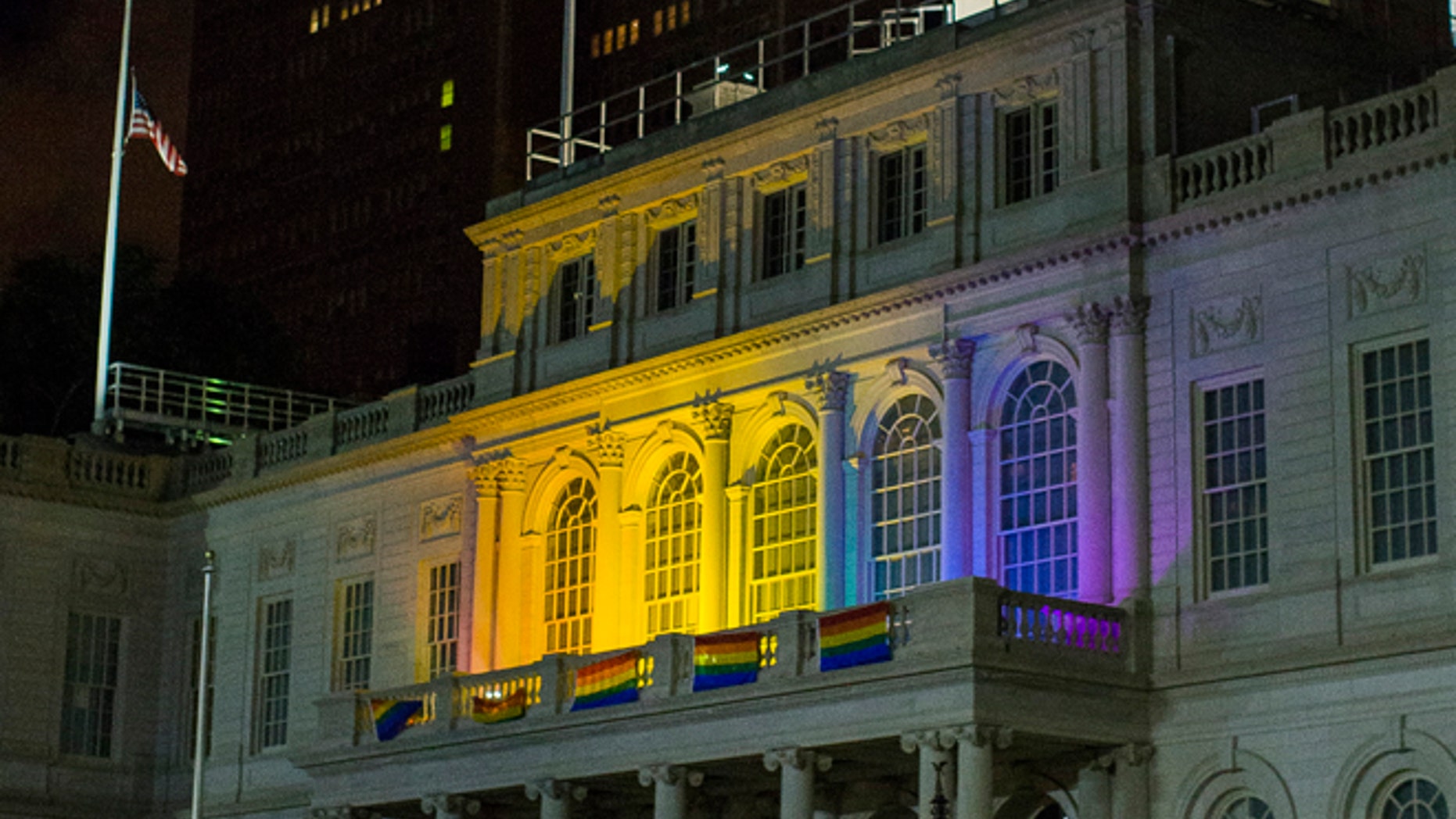 June 12, 2016: The New York City Hall building is illuminated in the colors of the LGBT pride flag in honor of the victims of the mass shooting in Orlando, Florida, in New York.