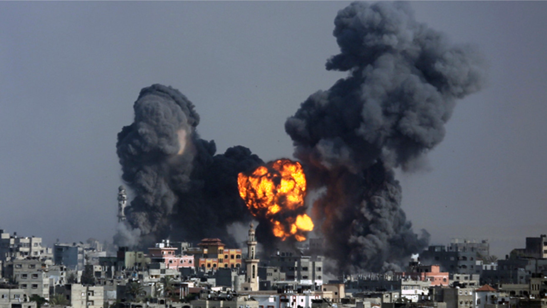 July 22, 2014: Smoke and fire from the explosion of an Israeli strike rise over Gaza City.