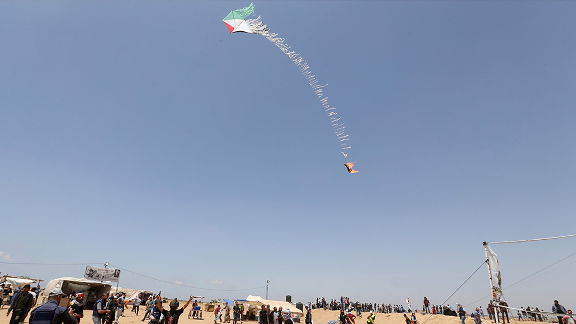 May 11, 2018: Palestinian demonstrators fly a flaming kite to be thrown at the Israeli side during a protest demanding the right to return to their homeland, at the Israel-Gaza border in the southern Gaza Strip.