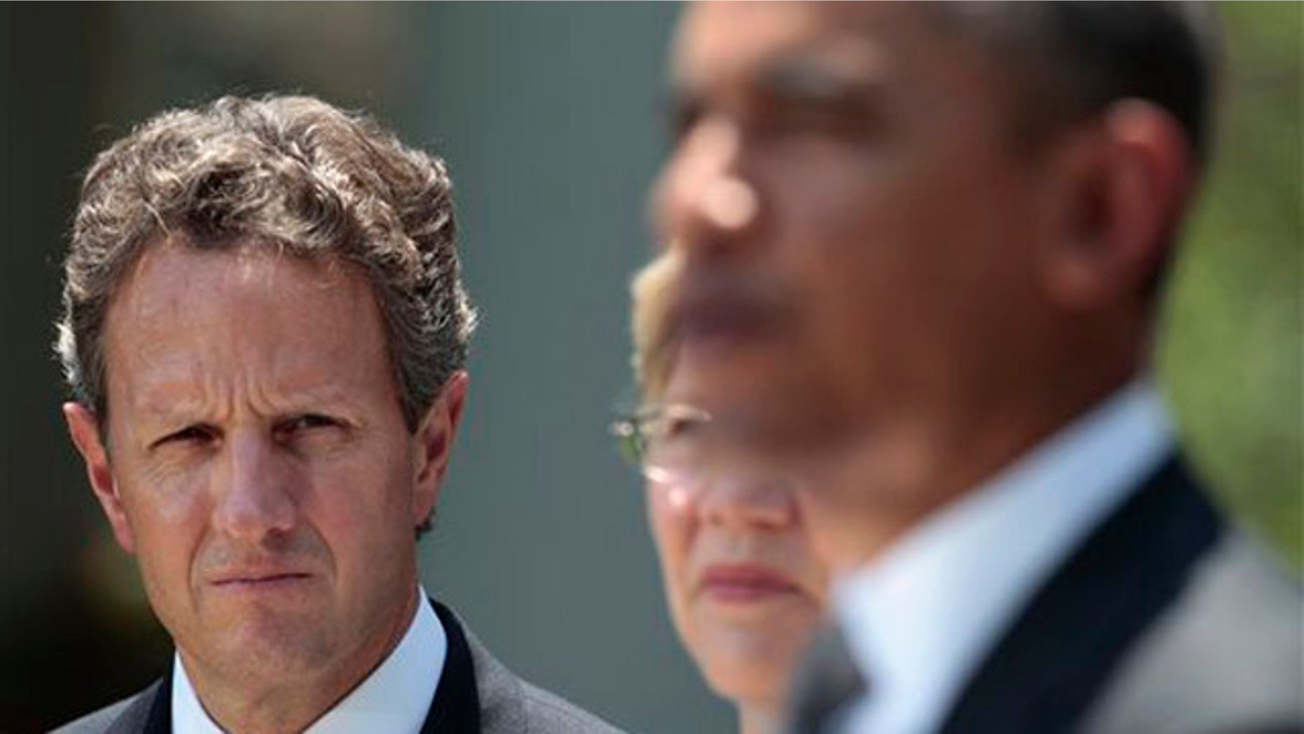 Treasury Secretary Timothy Geithner, left, and Elizabeth Warren, center, listen to President Obama July 18 in the Rose Garden in Washington.