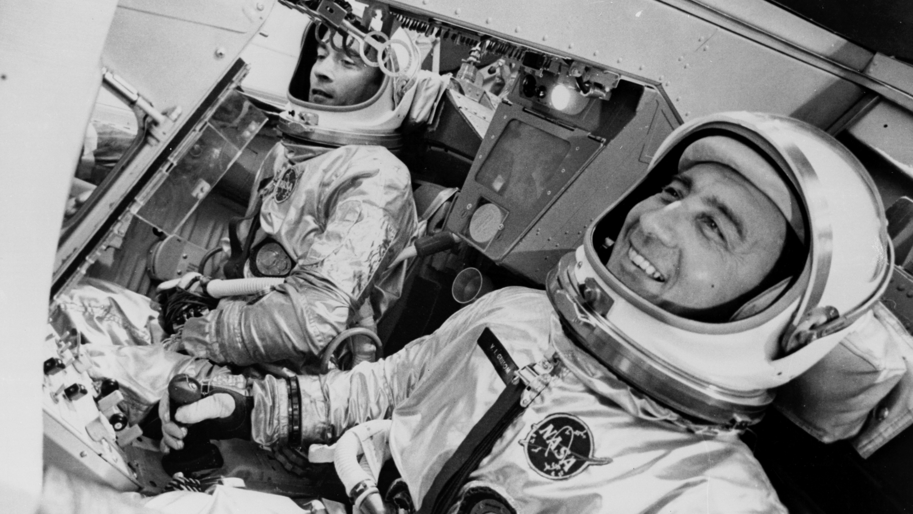 John Young (left) and Gus Grissom flew on the first crewed Gemini flight, Gemini 3, on March 23, 1965. Here, they're shown in the spacecraft simulator at the McDonnell plant in St. Louis. One additional "passenger" on the real flight was a corned-beef sandwich that Young smuggled aboard in his pocket.