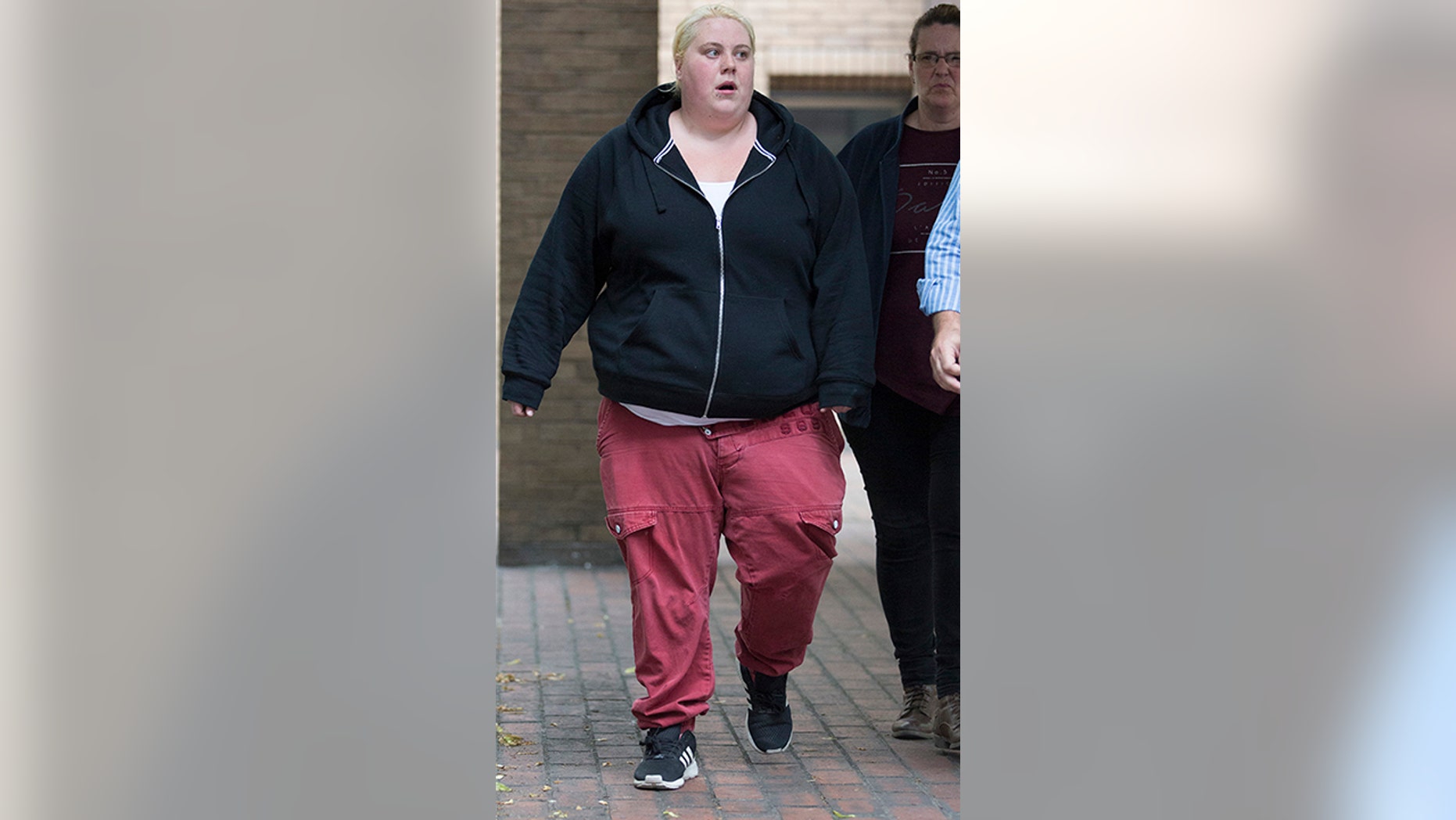 Jemma Beale walks to Southwark Crown Court in London for her trial on charges of perjury and perverting the course of justice