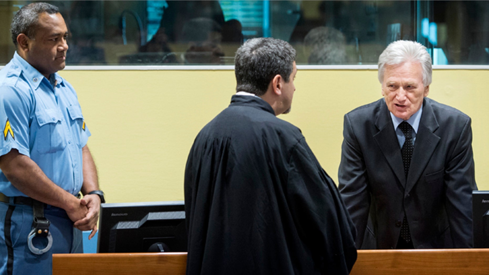 Feb. 28, 2013: Gen. Momcilo Perisic, the former chief of staff of the Yugoslav national army, right, talks to his lawyer prior to his appeal judgment in the court room of the Yugoslav war crimes tribunal in The Hague, Netherlands.