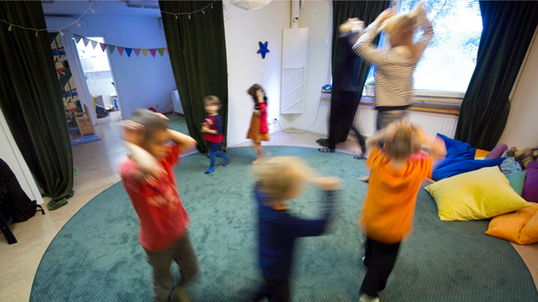 June 20: A teacher plays with children at "Egalia," a Swedish preschool aiming at gender stereotypes in Stockholm, Sweden. At the preschool, staff avoid using words like "him" or "her" and address the children as "friends" rather than girls and boys. Every little detail has been carefully planned from the color and placement of toys to the selection of literature to make sure the 30 or so children don't fall into gender stereotypes.
