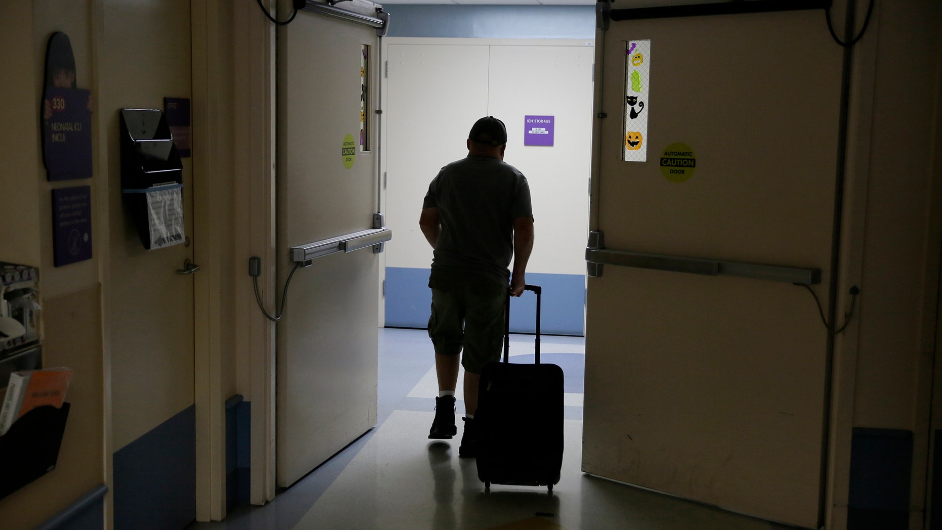 In this photo taken Monday Nov. 6, 2017, Brian Madeux, 44, makes his way through the UCSF Benioff Children's Hospital in preparation for the first human gene editing therapy in Oakland, Calif. Madeux, who has Hunter syndrome, received the treatment on Monday, Nov. 13. (AP Photo/Eric Risberg)
