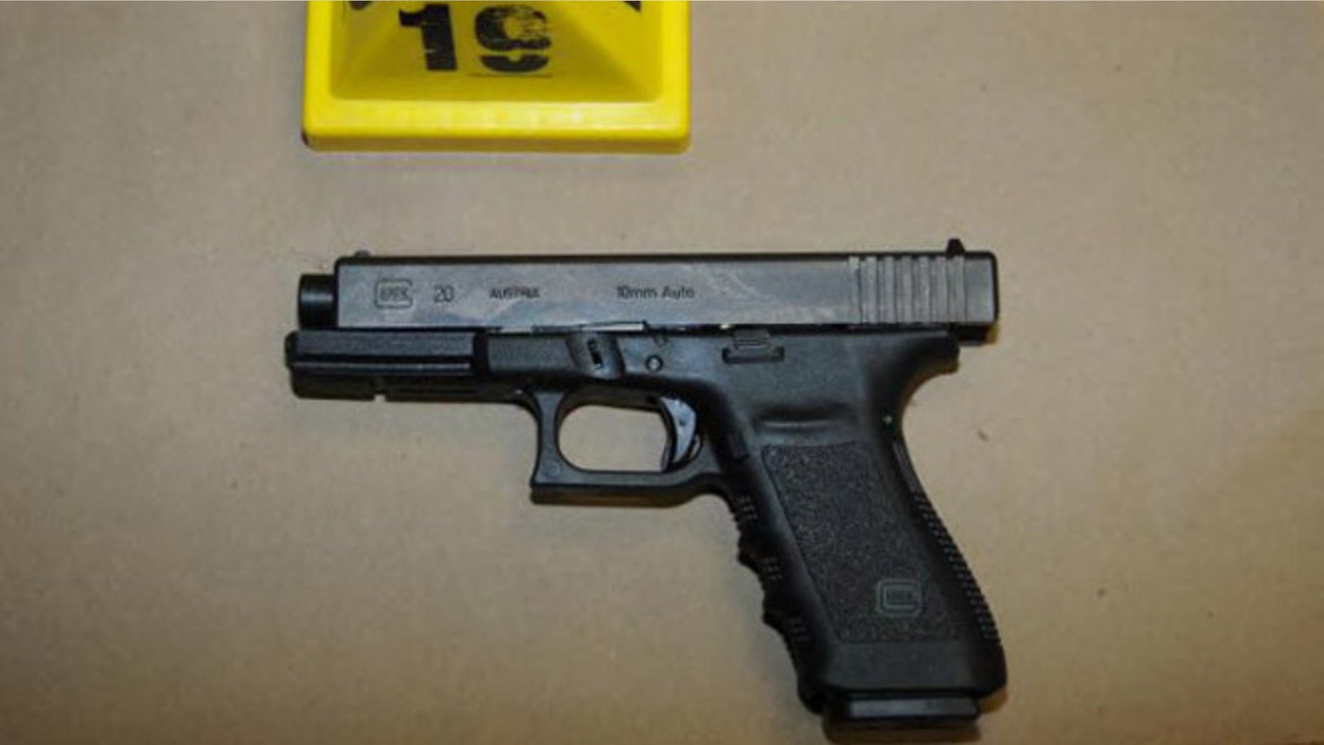 NEWTOWN, CT - UNSPECIFED DATE: In this handout crime scene evidence photo provided by the Connecticut State Police, shows a Glock 20, 10mm found near the shooter in Room 10 at Sandy Hook Elementary School following the December 14, 2012 shooting rampage, taken on an unspecified date in Newtown, Connecticut . A report was released November 25, 2013 by Connecticut State Attorney Stephen Sedensky III summarizing the Newtown school shooting that left 20 children and six women dead inside Sandy Hook Elementary School. According to the report, a motive behind the shooting by gunman Adam Lanza is still unknown. (Photo by Connecticut State Police via Getty Images)