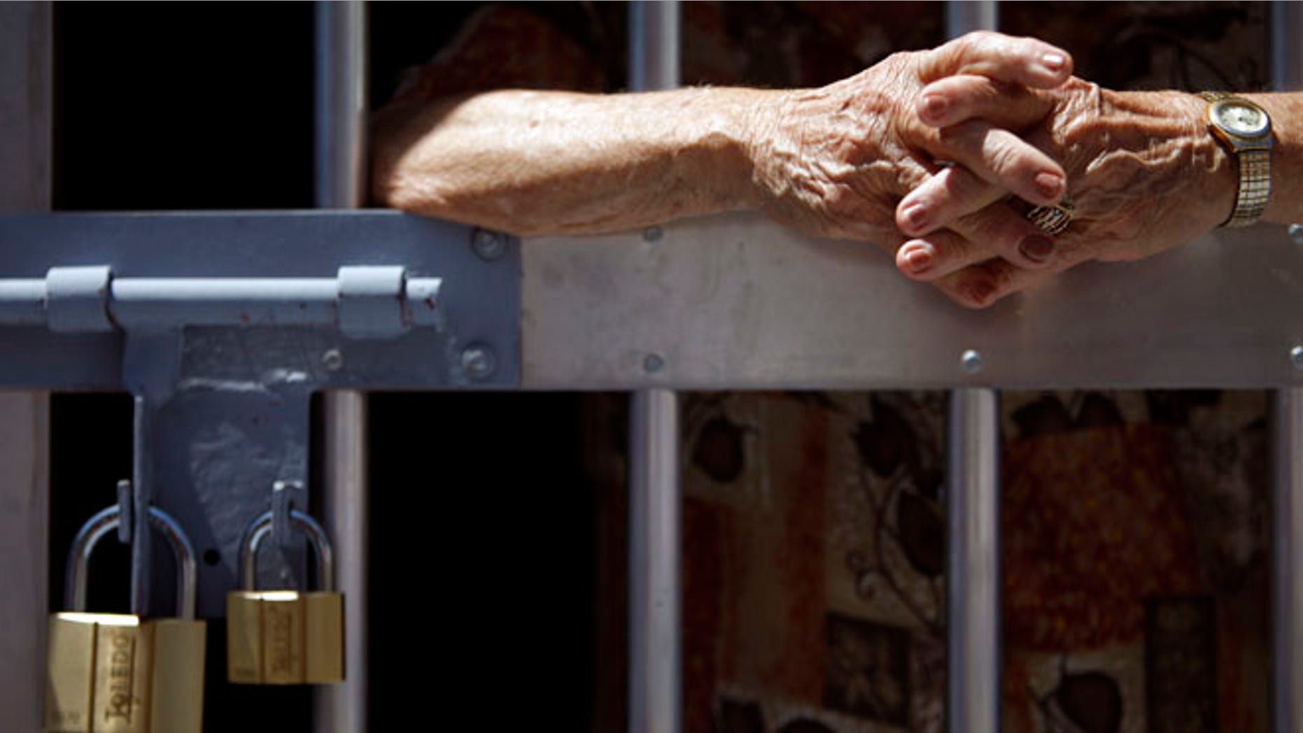 May 29, 2013: Unidentified man stands behind prison bars.