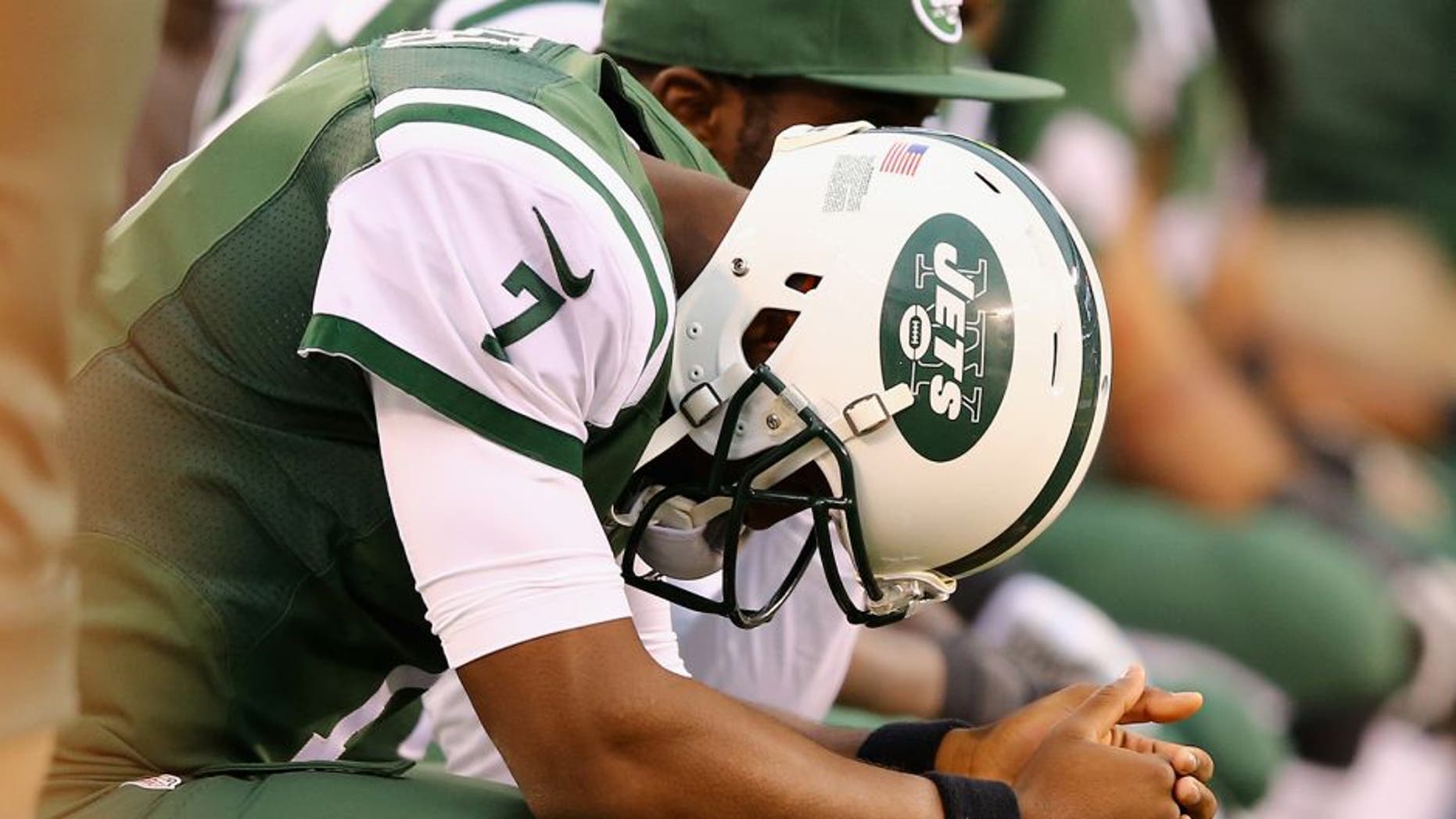 EAST RUTHERFORD, NJ - OCTOBER 26: Quarterback Geno Smith #7 of the New York Jets reactrs on the bench in the fourth quarter against the Buffalo Bills at MetLife Stadium on October 26, 2014 in East Rutherford, New Jersey. The Bills won 43-23. (Photo by Al Bello/Getty Images)