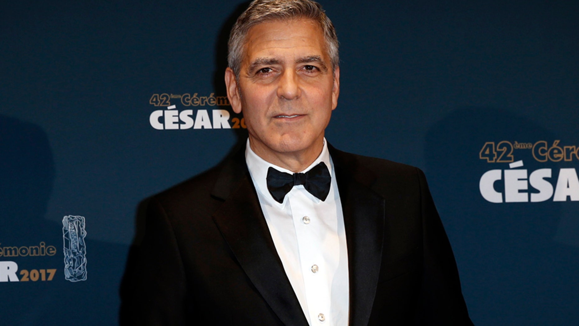 Actor George Clooney holds his trophy during a photocall after receiving an Honorary Cesar Award at the 42nd Cesar Awards ceremony in Paris, France, February 24, 2017.
