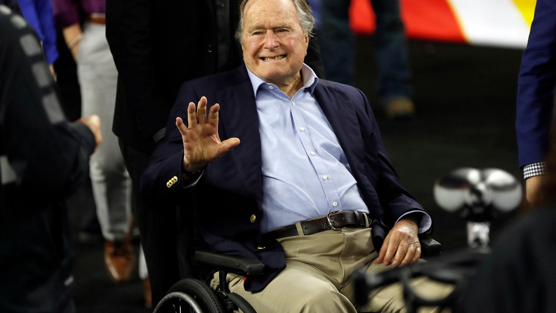 FILE - In this April 2, 2016, file photo, former President George H. W. Bush waves as he arrives at NRG Stadium before the NCAA Final Four tournament college basketball semifinal game between Villanova and Oklahoma in Houston. Houston-area media are quoting former President George H.W. Bush's chief of staff as saying that Bush has been hospitalized in Houston. (AP Photo/David J. Phillip, File)