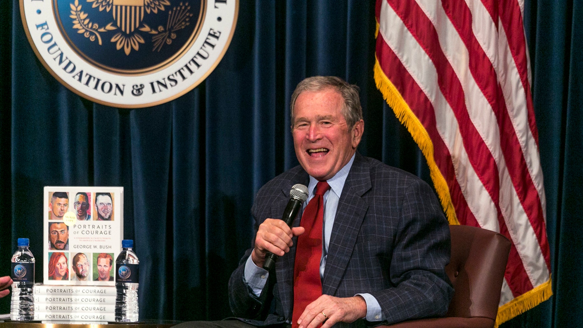 Former U.S. President George W. Bush discusses his new book "Portraits of Courage: A Commander in Chief's Tribute to America's Warriors," a collection of his artwork featuring paintings of veterans and stories at the Ronald Reagan Presidential Library in Simi Valley, Calif., Wednesday, March 1, 2017. (AP Photo/Damian Dovarganes)
