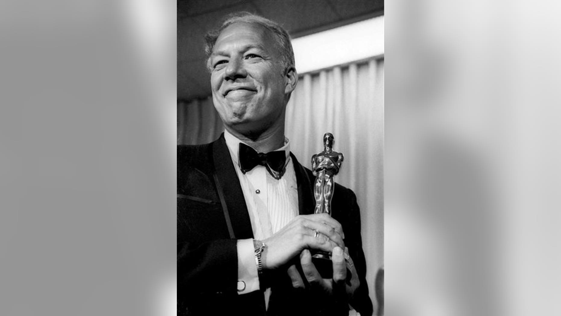 In this April 10, 1968, file photo, George Kennedy poses with his Oscar in Santa Monica, Calif, after winning best supporting actor for "Cool Hand Luke."