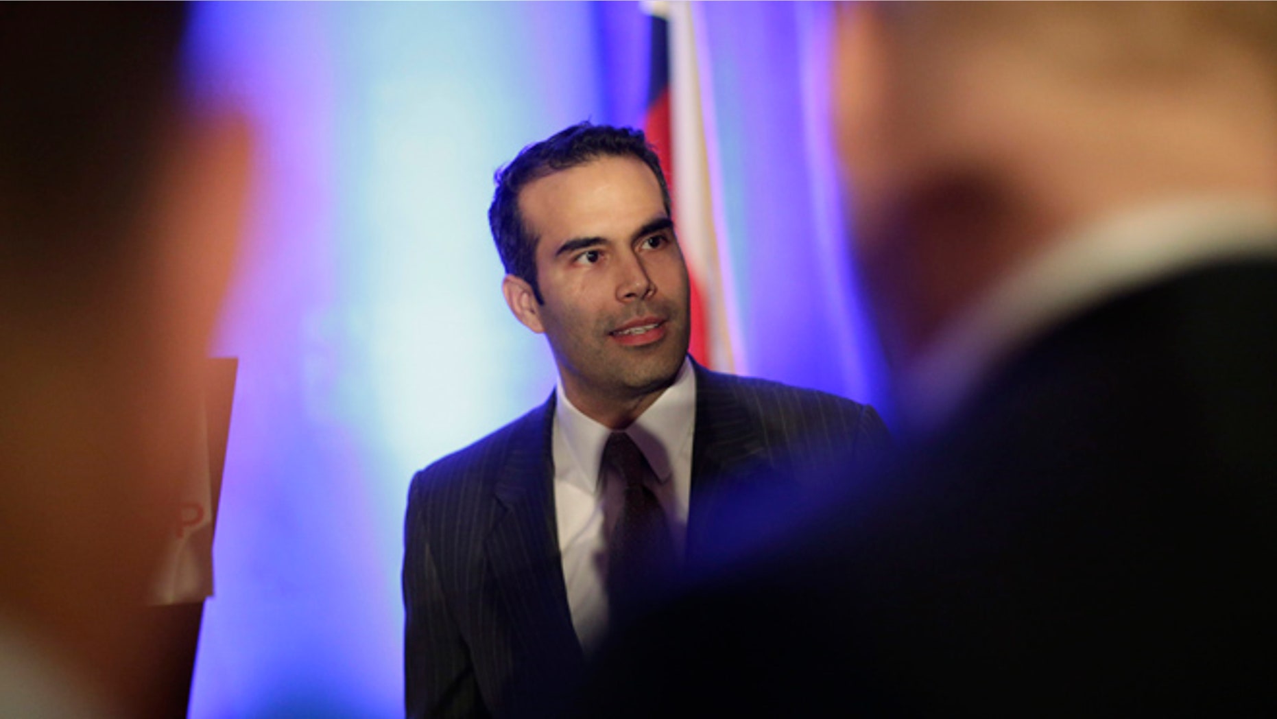 Feb. 26, 2013: In this file photo, George P. Bush, left, talks to businessmen prior to making the opening statements at the Texas Business Leadership Council in Austin, Texas.