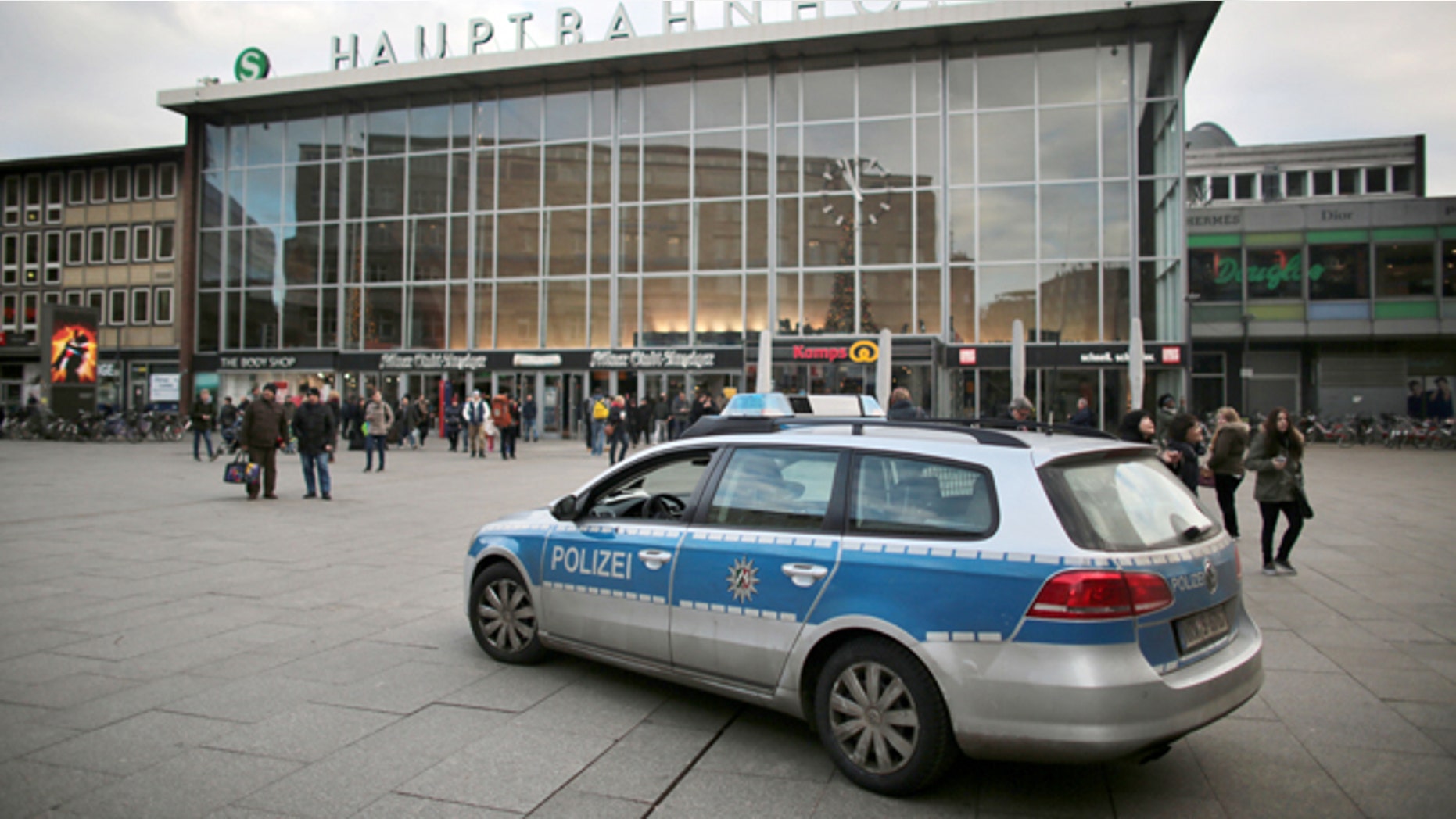People walk past the central railway station in Cologne, Germany, Tuesday Jan. 5, 2016. City officials and police in Cologne are holding a crisis meeting following a series of sex assaults in the western German city on New Year's Eve
