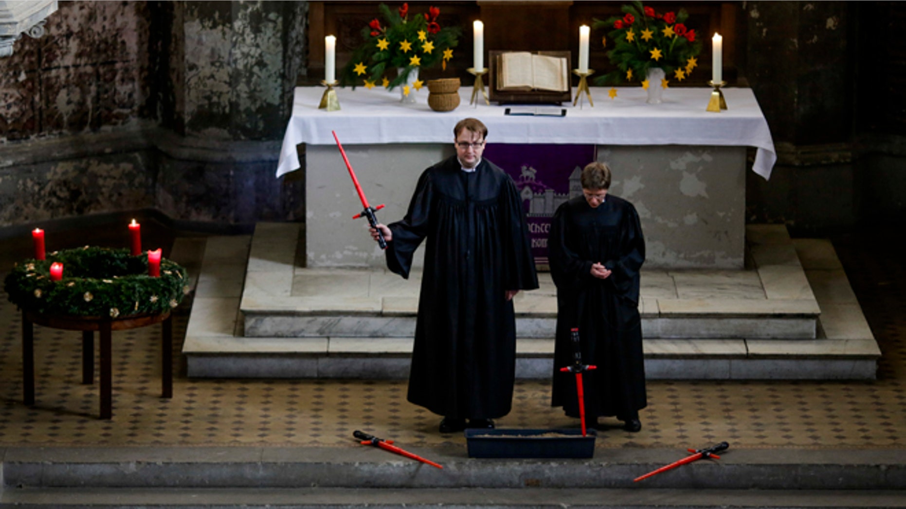 December 20, 2015. Vicars Lucas Ludewig, left, and Ulrike Garve, right, celebrate a Star Wars themed church service, at the Zion Church in Berlin, Germany.