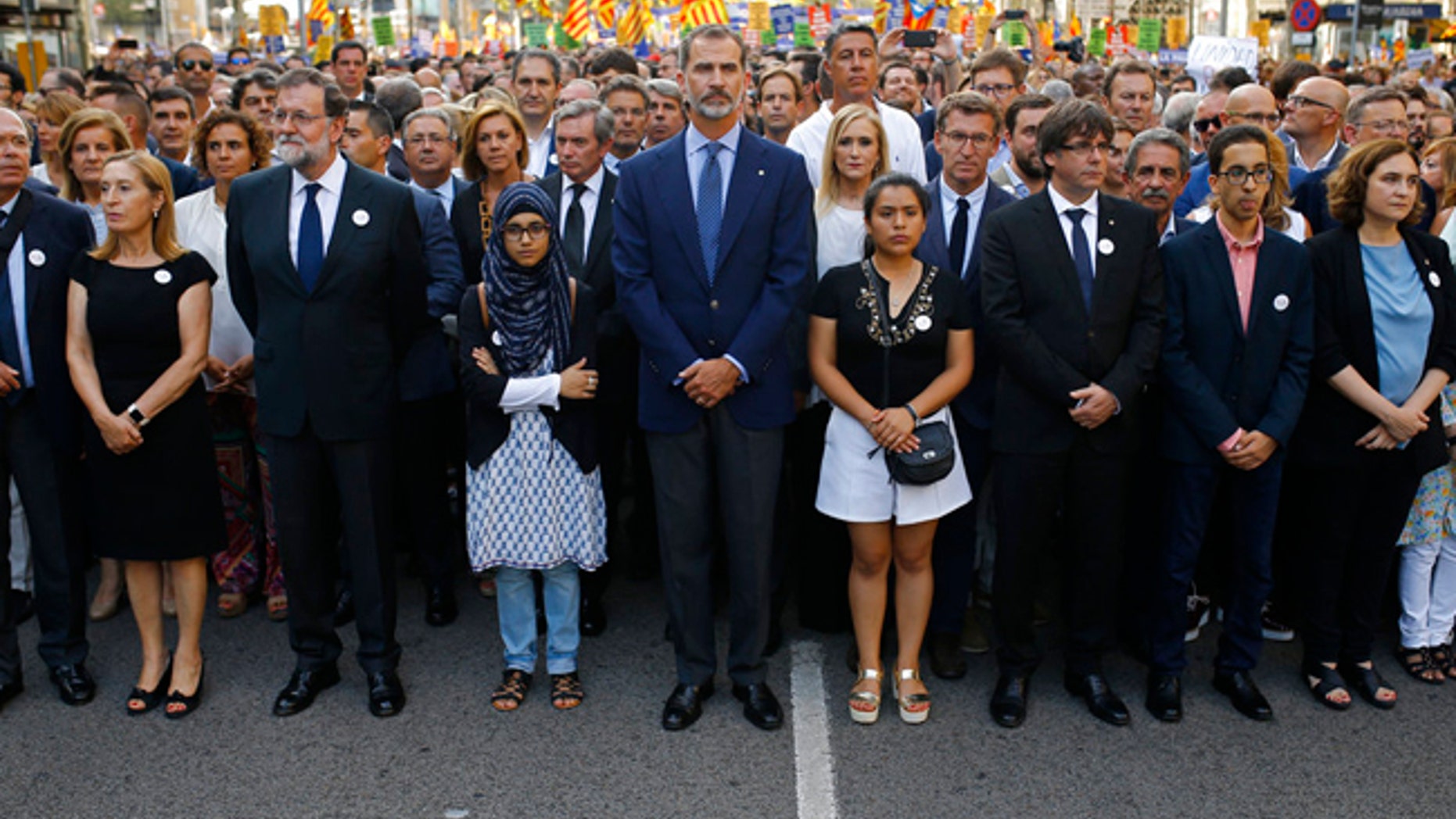 Spain's King Felipe, centre, Spain's Prime Minister Mariano Rajoy, 3rd left and Catalonia regional President Carles Puigdemont, 4th from right and other politicians take part in a demonstration condemning the attacks that killed 15 people last week in Barcelona, Spain, Saturday, Aug. 26, 2017.