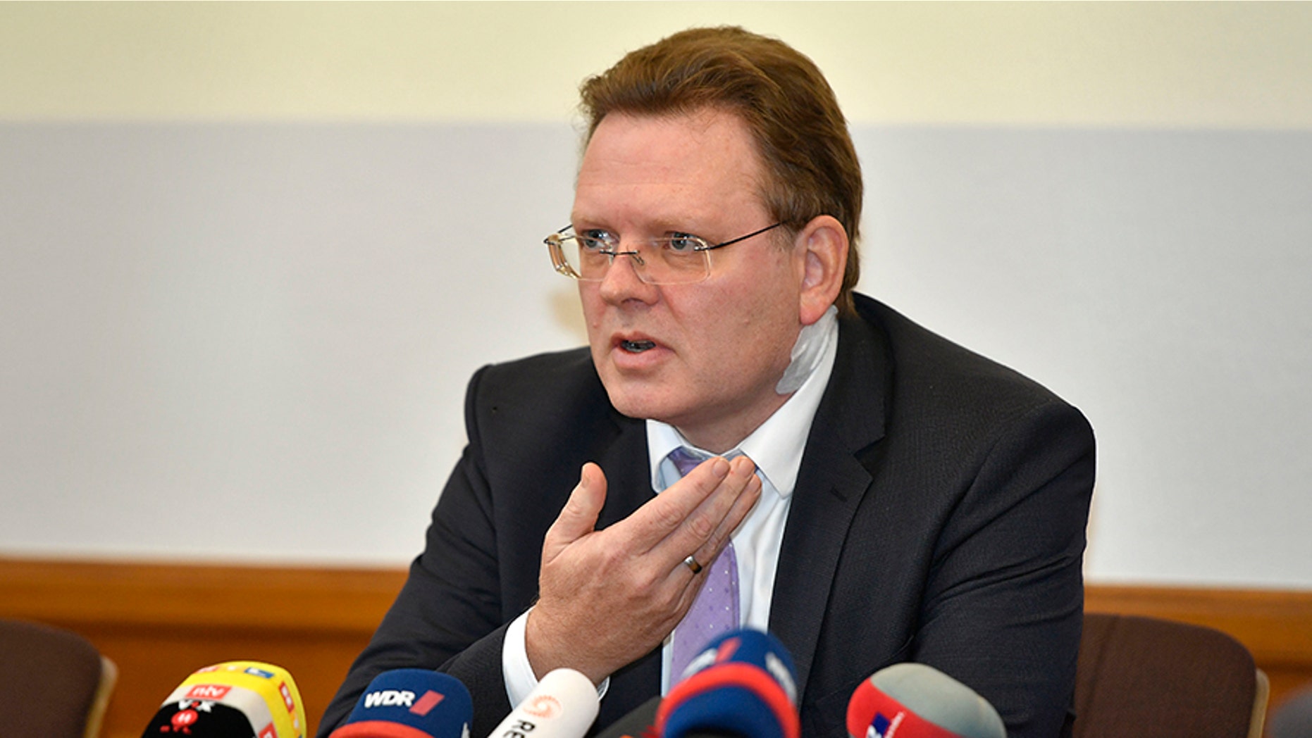Mayor Andreas Holstein talks to the media in a press conference at the town hall in Altena, Germany, Tuesday, Nov. 28, 2017. The mayor suffered a neck injury when he was stabbed at a kebab restaurant Monday night. The attack was likely political motivated. (AP Photo/Martin Meissner)