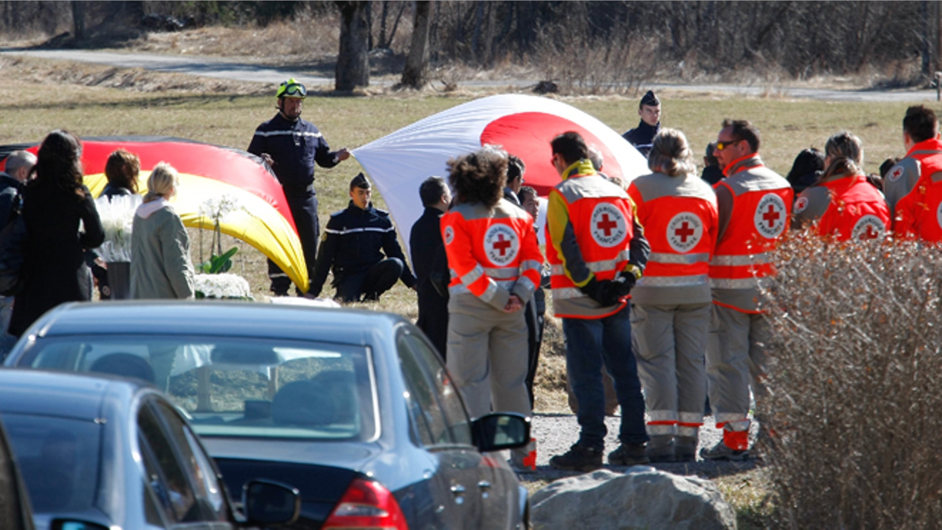 March 29, 2015: The German, left, and Japanese flags are deployed during an homage ceremony with family members of Japanese victims in the area where the Germanwings jetliner crashed in the French Alps, in Le Vernet, France.