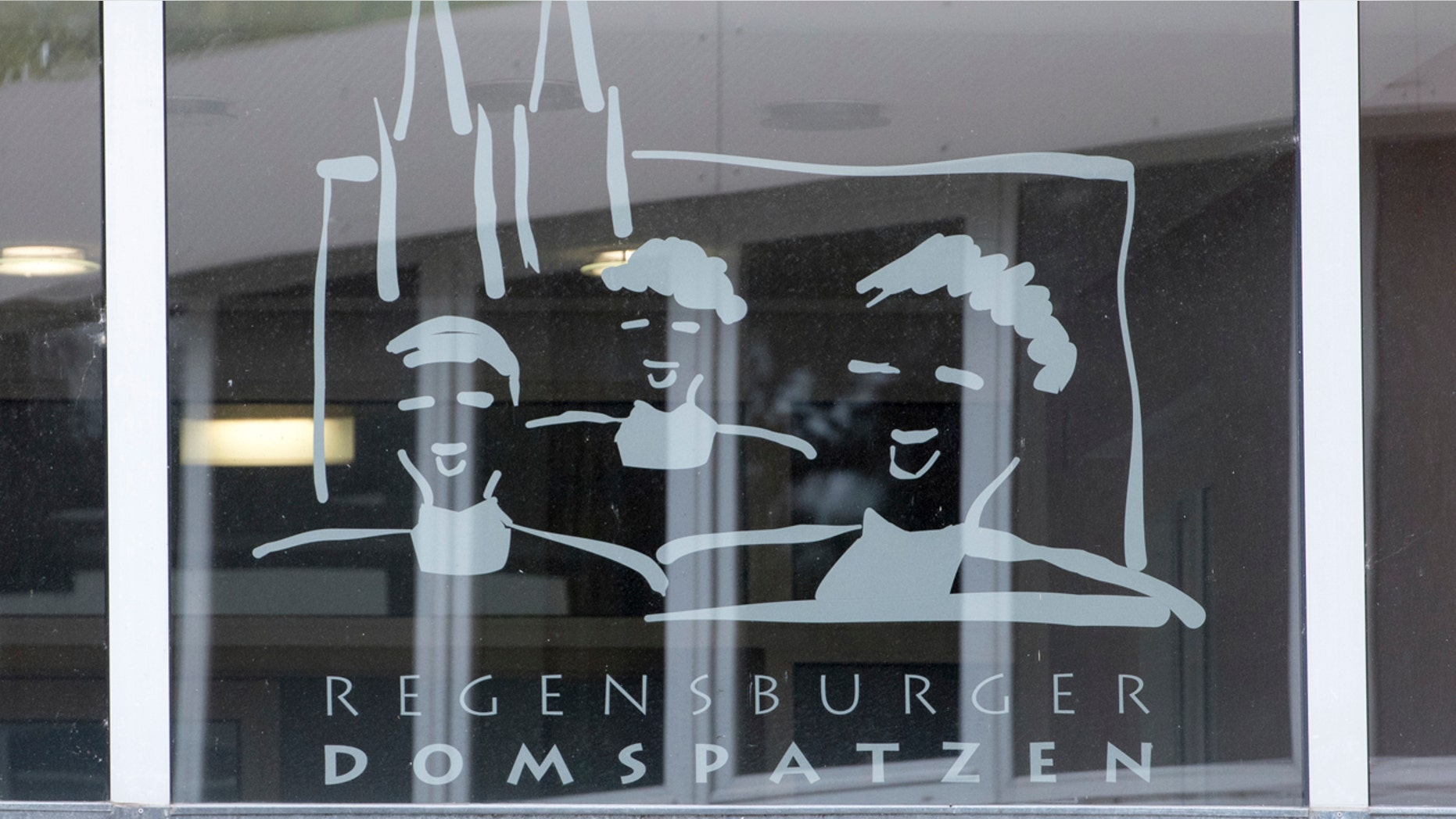 This Oct. 12, 2016 file photo shows the logo of the Regensburger Domspatzen choir at a window of the high school in Regensburg.