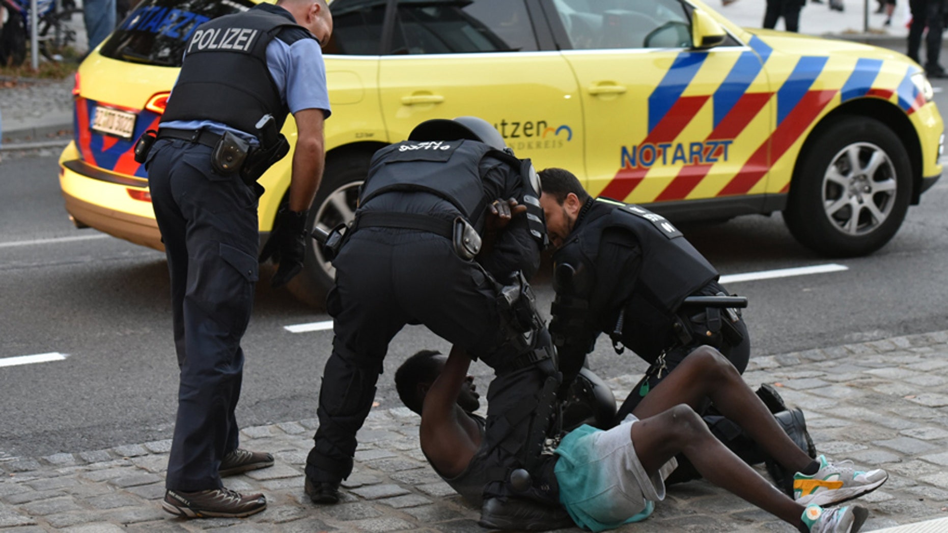 Sept. 10, 2016: Police officers take a man into custody during a gathering on a square at the Kornmarkt in Bautzen, Germany.