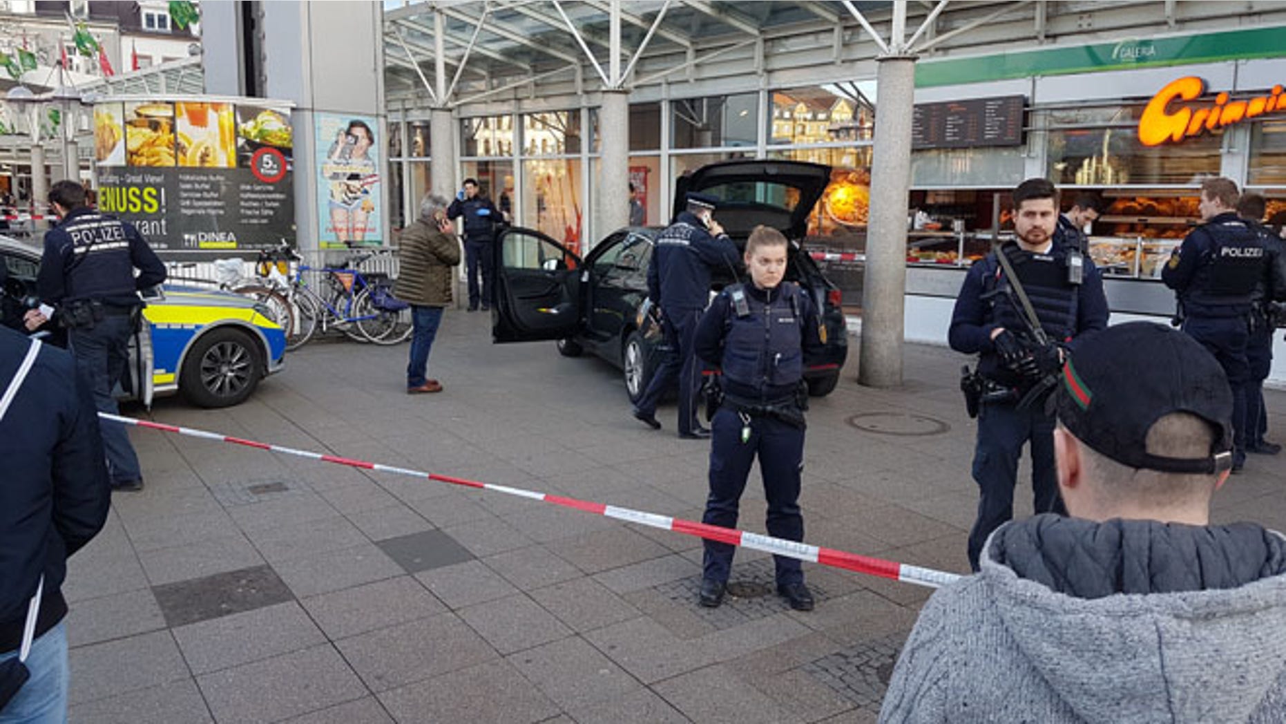 Police guard a car that crashed into pedestrians in Heidelberg, Germany, Saturday. (Priebe/PR-Video/dpa via AP)