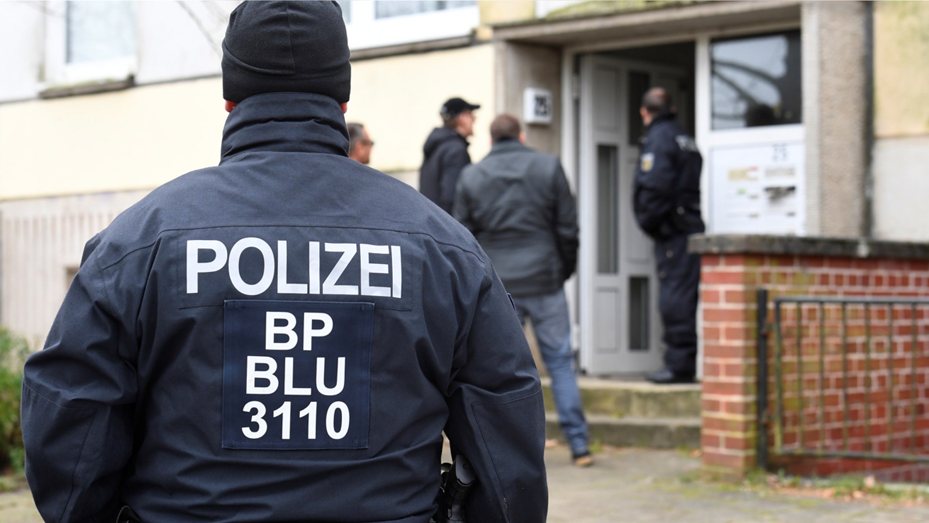 Police conduct a raid in front of a residential building in Schwerin, Germany in October.