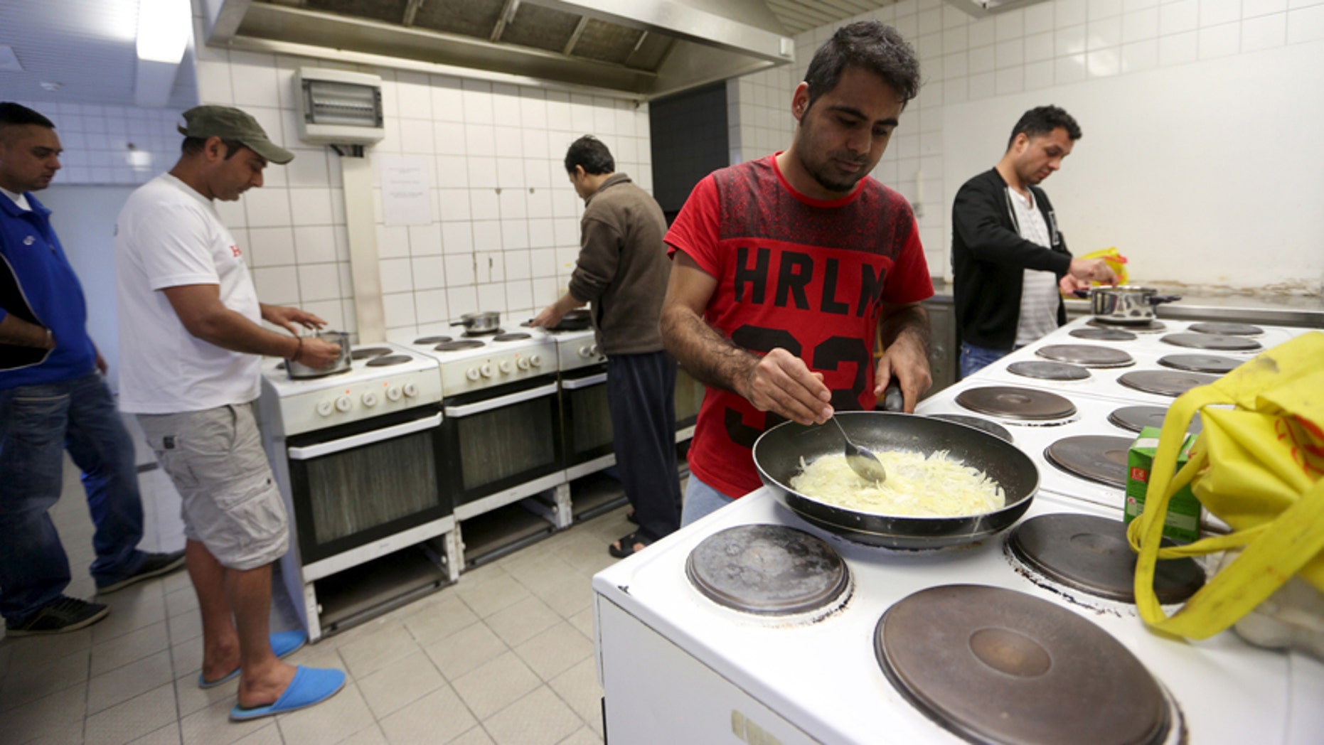 March 24, 2016: Migrants cook in the kitchen of the accommodation for migrants "Spree Hotel" in Bautzen, Germany.
