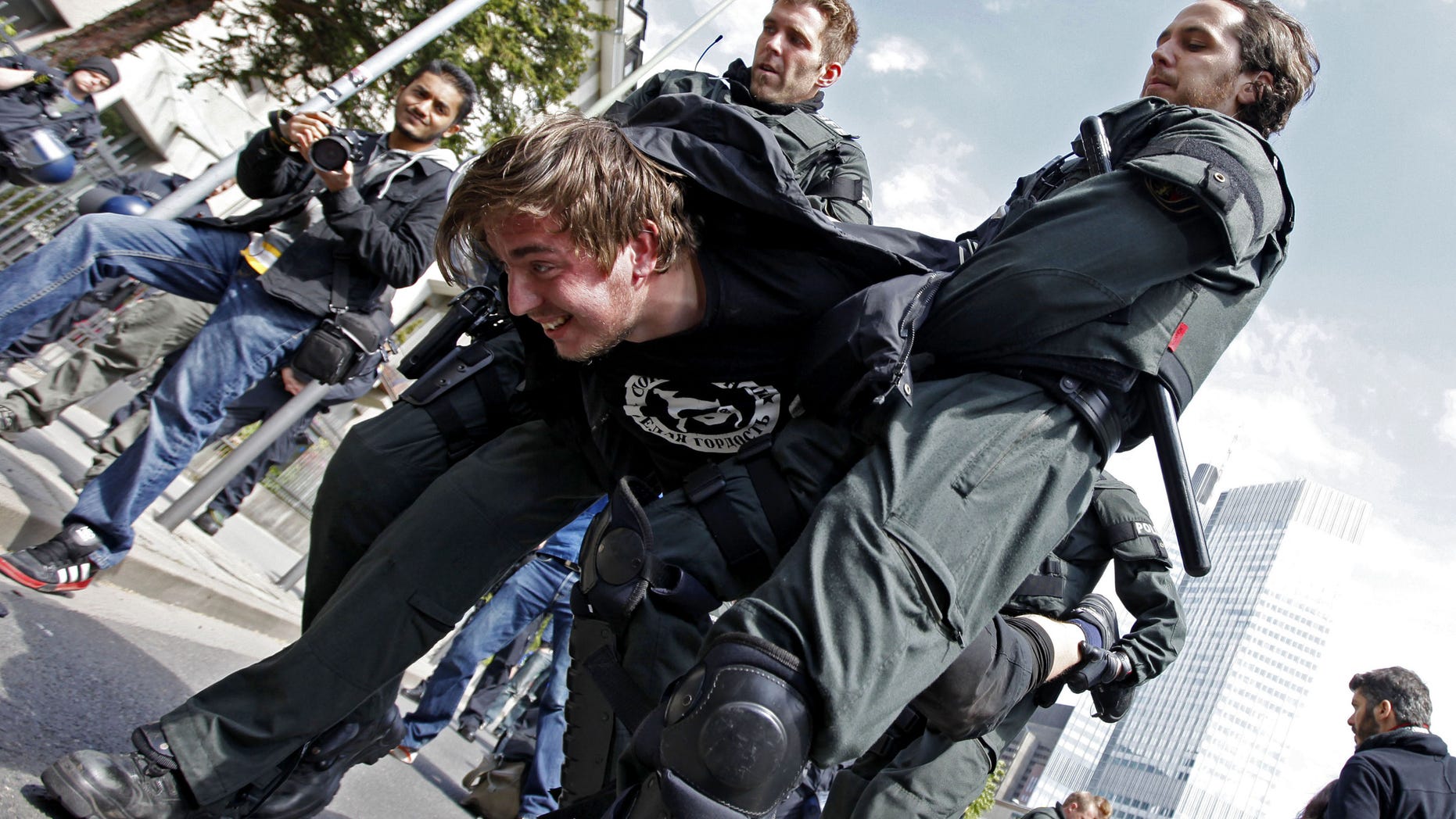May 18, 2012: Police carry a protester away, after demonstrators had blocked a street in Frankfurt, central Germany. Police in Germany have temporarily detained some 400 demonstrators during largely peaceful protests by Occupy activists.