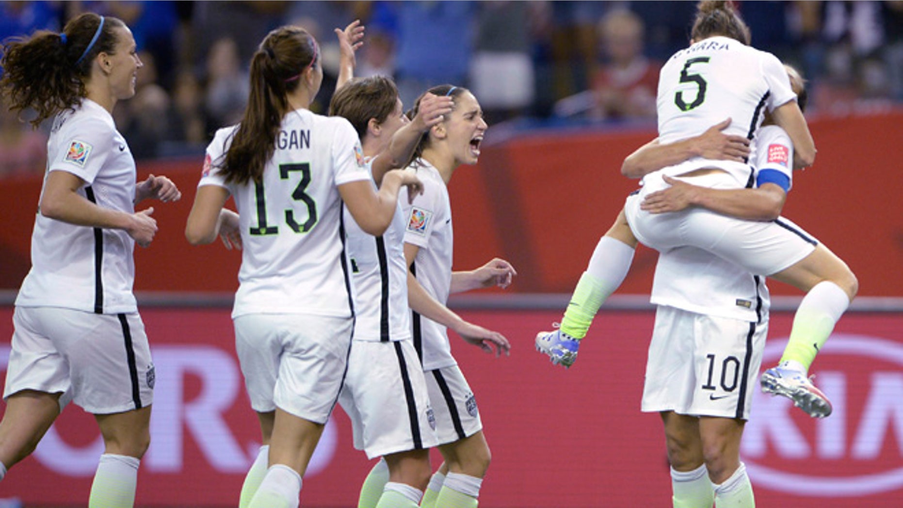 June 30, 2015: United States' Kelly O'Hara (5) jumps into the arms of Carli Lloyd after O'Hara scored against Germany during the second half of a semifinal in the Women's World Cup soccer tournament in Montreal, Canada. (AP)