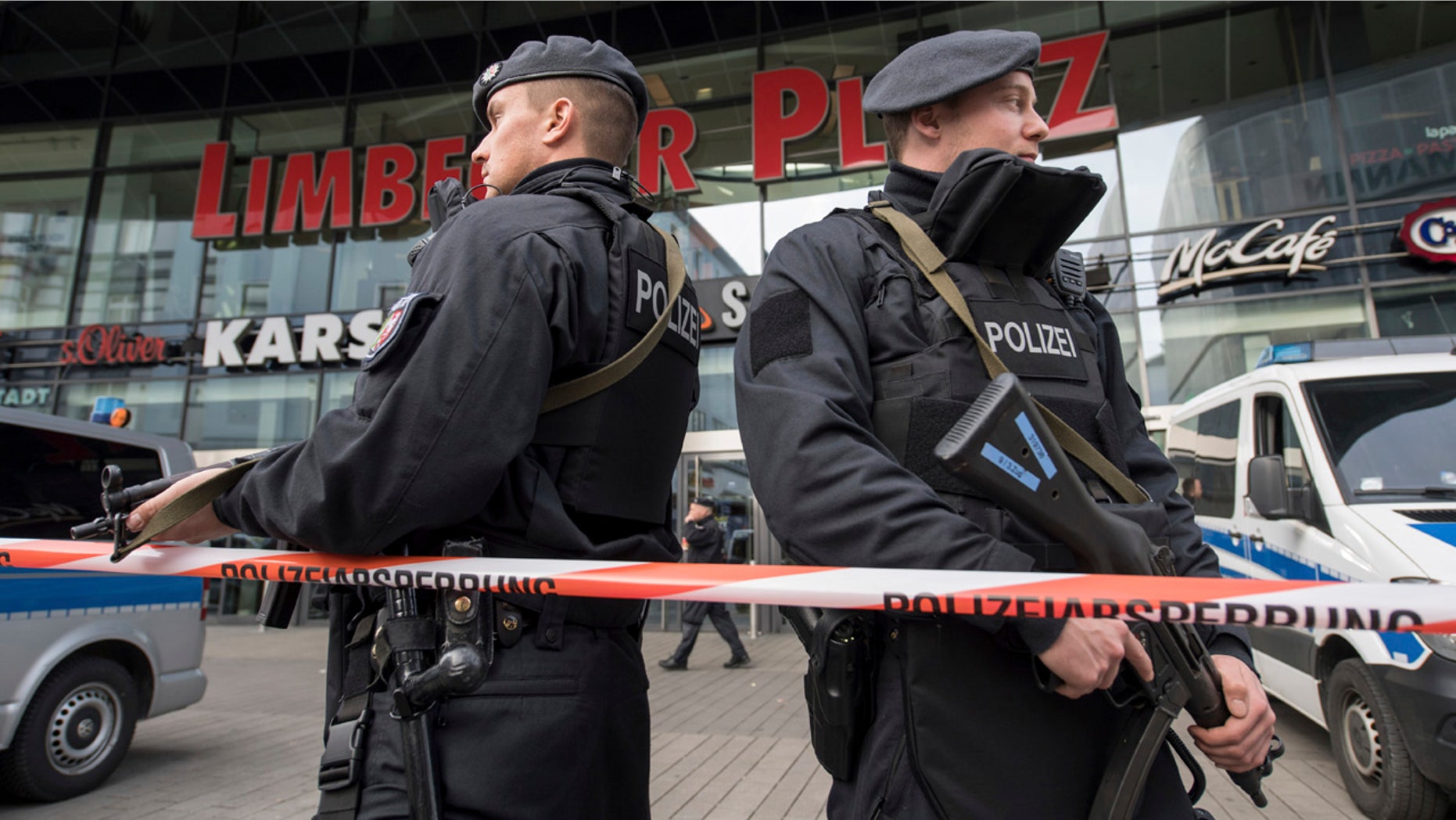 Police guard in front of a shopping mall in Essen, Germany, Saturday, March 11, 2017.