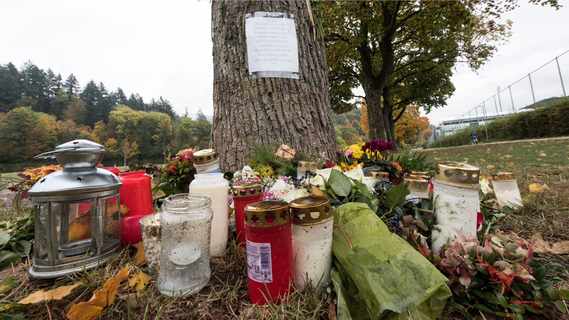 Oct. 21, 2016: Flowers and candles sit in front of a tree close to the Dreisam river in Freiburg, Germany, where the body of a student was found. A 17-year-old Afghan migrant, who entered Germany last year as an unaccompanied minor, was arrested Friday in connection with the killing.