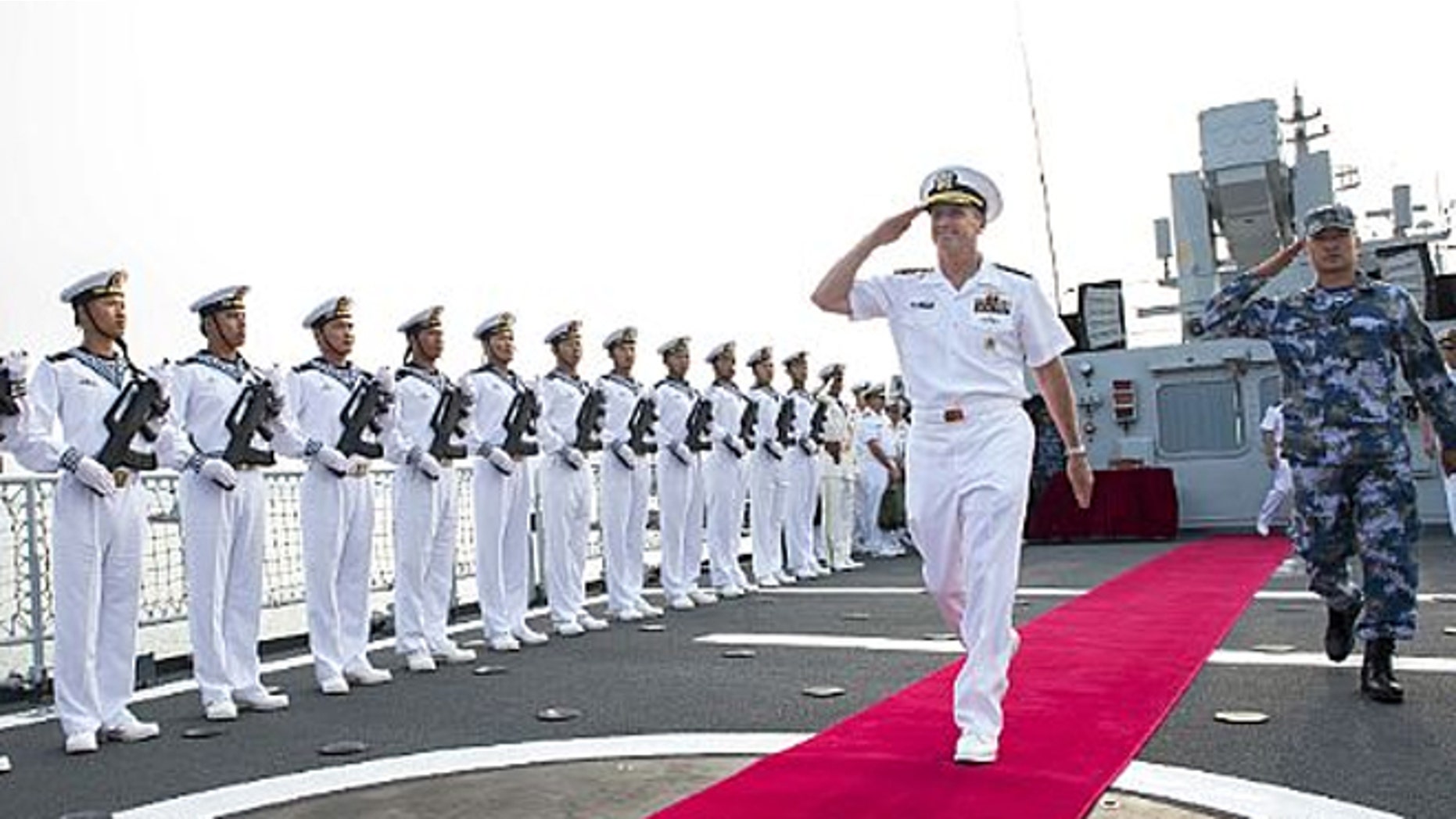 July 17: Chief of Naval Operations Adm. Jonathan Greenert departs the Chinese Datong FFG 580 with the ship's commanding officer after touring the ship. Greenert said military relations between the U.S. Navy and China have improved.