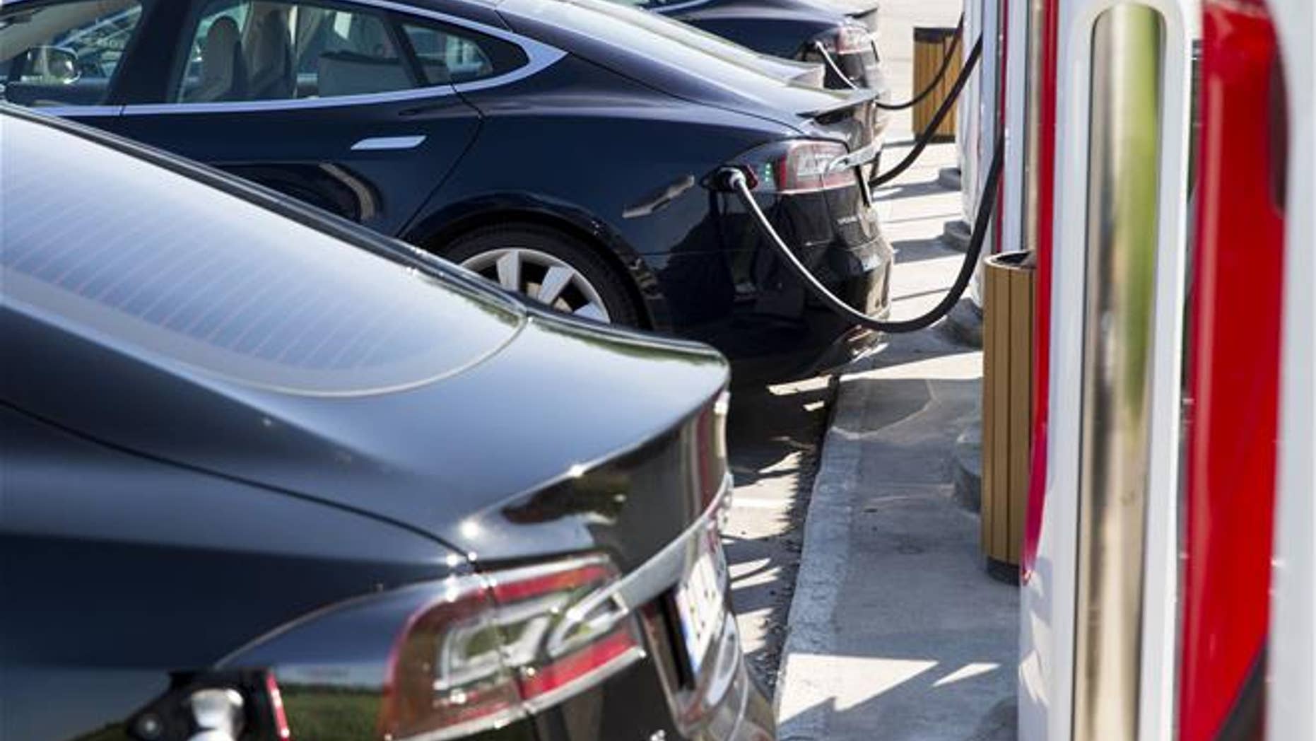 In this June 4, 2016 file photo, electric Tesla cars park at a supercharger facility in Sarpsborg, Norway (Tore Meek / NTB scanpix via AP, File).