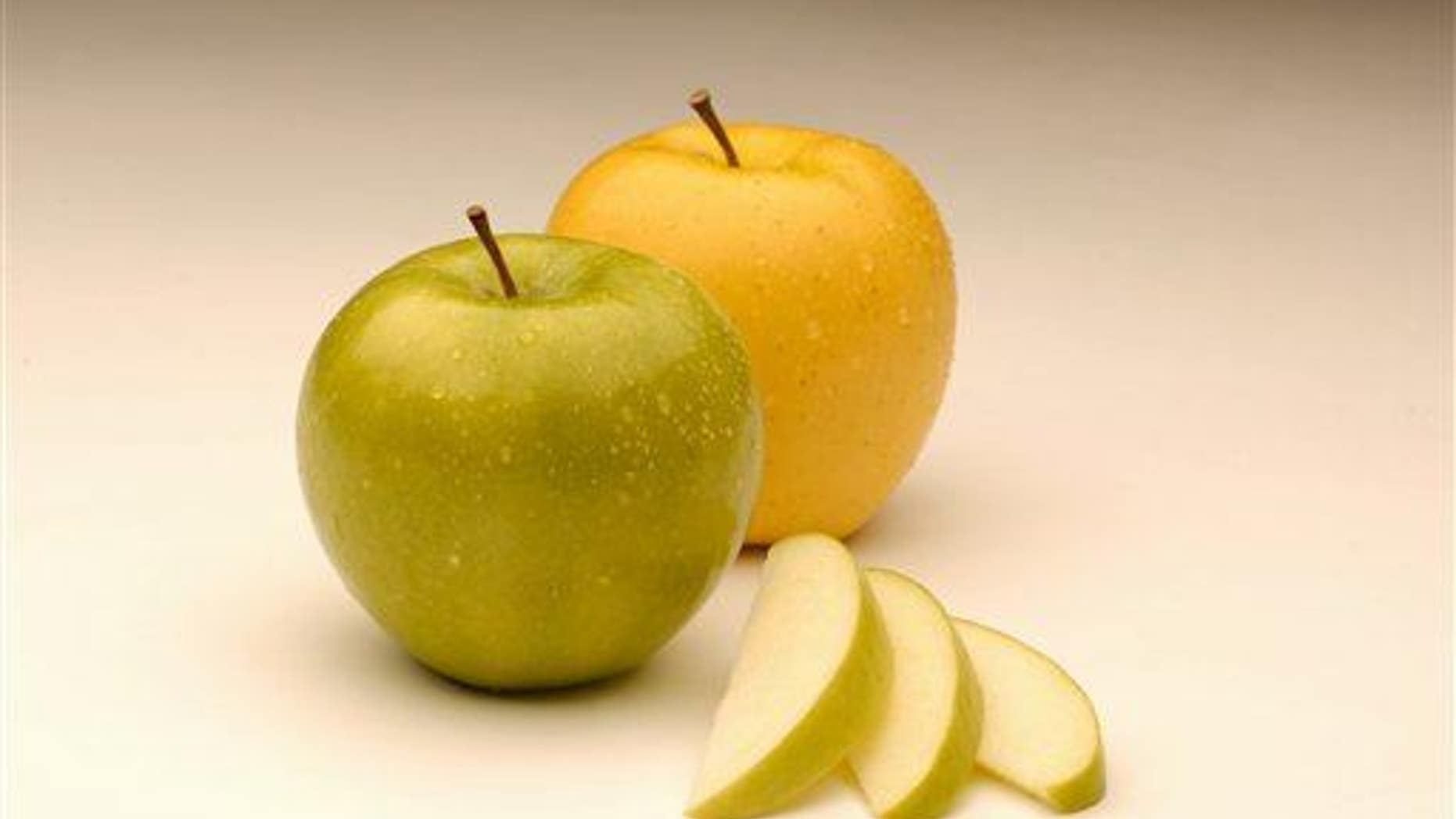 An Arctic Granny apple, left, from Canada's Okanagan Specialty Fruits is seen with an Arctic Golden variety, right.
