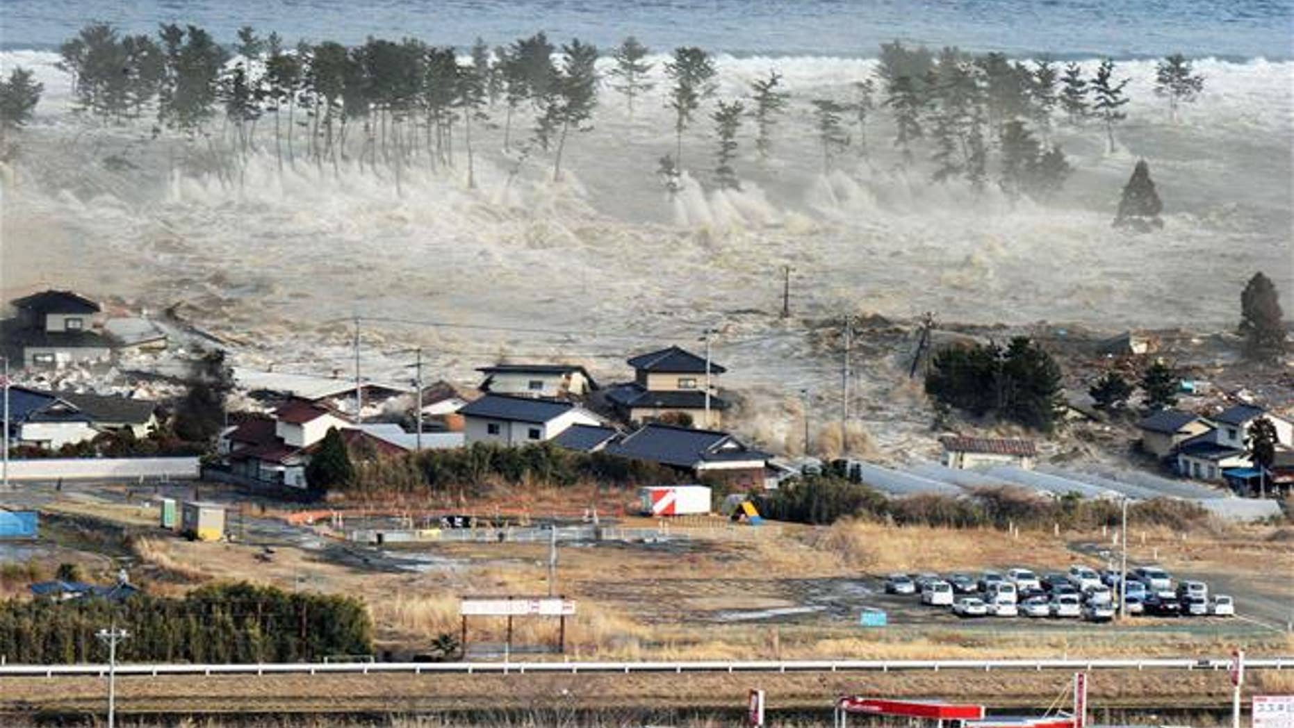 In this March 11, 2011 aerial photo, a tsunami hit Natori, Miyagi Prefecture, northeastern Japan. (Kyodo News via AP, File)