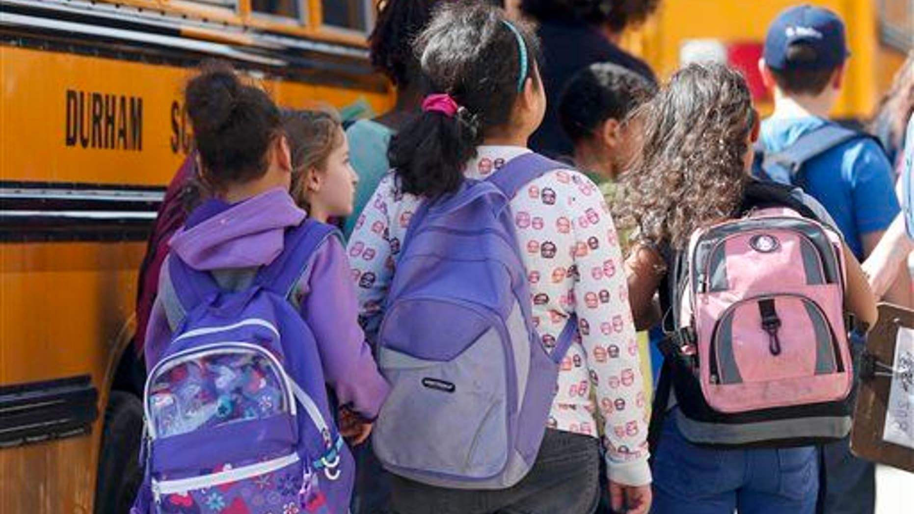 Kids get ready to board the school bus.