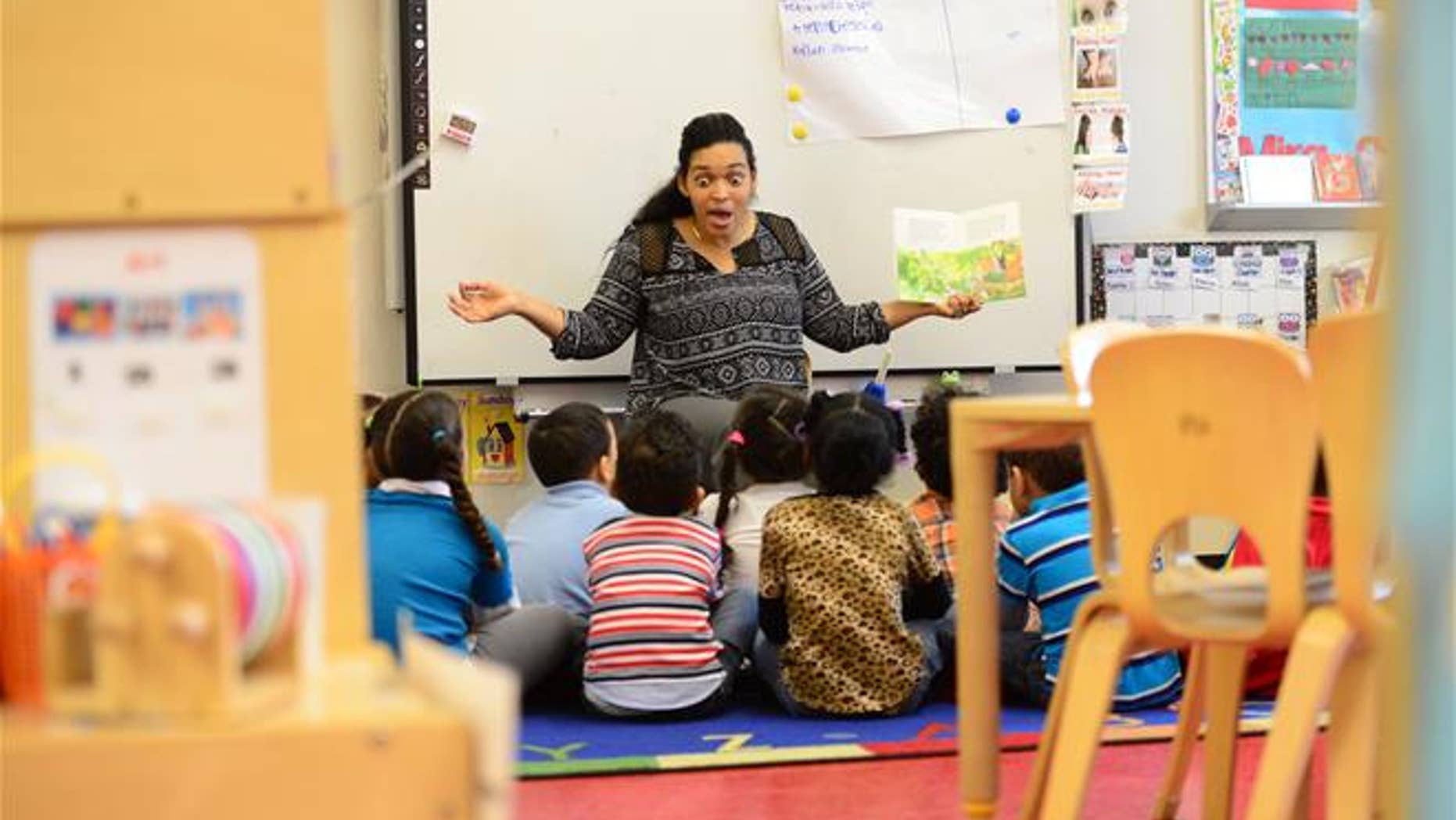 Dec. 10, 2015: A pre-K teacher reads to her class at Madison K Center in Paterson, N.J.