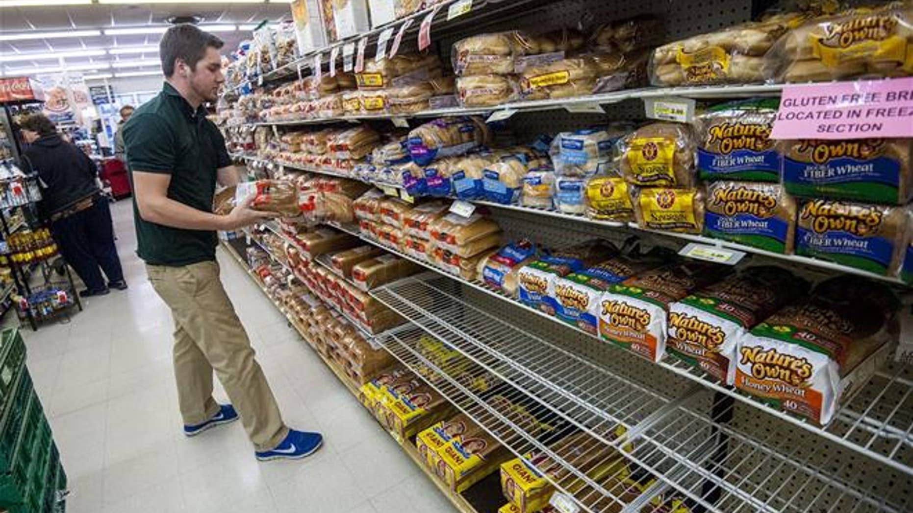 Bridgewater College junior communication major Jonah Barnhart, of Culpepper, Va., a floor stocker at Bridgewater Foods, stocks the bread aisle on Wednesday, Jan. 20, 2015, in Bridgewater, Va.
