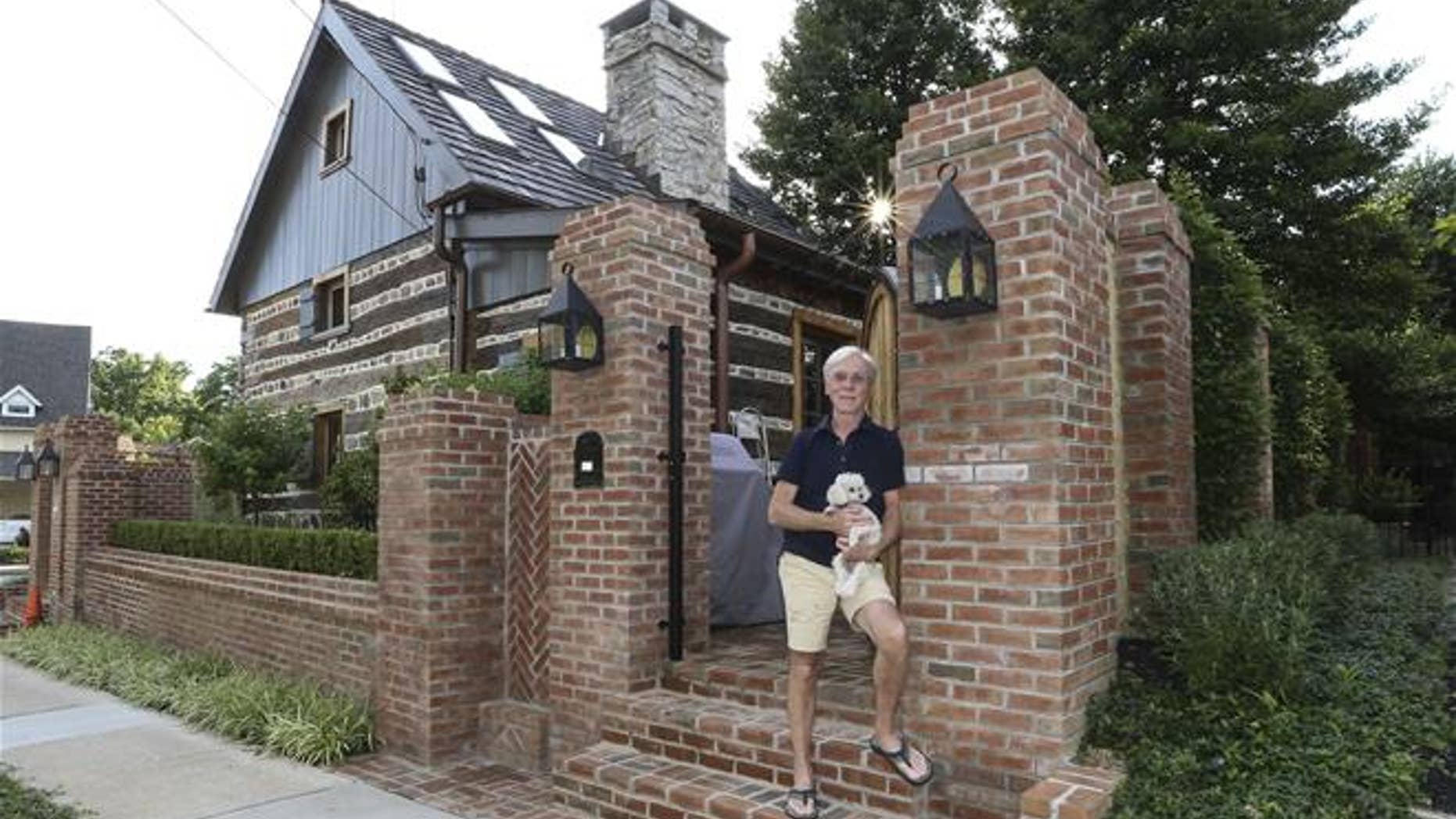 Jude Plum, with his dog, at his 300-year-old log home in Bryn Mawr, Pa.