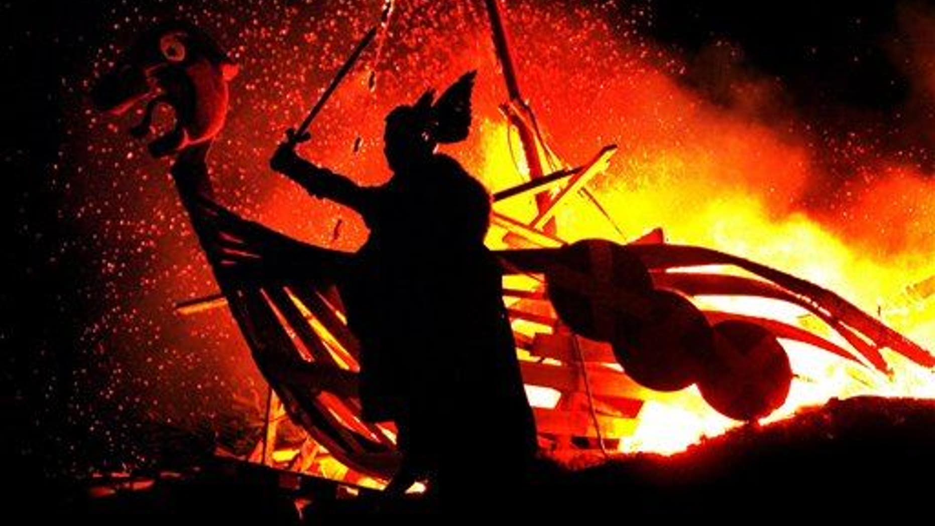 A reveler dressed as a Viking takes part in a 'Torchlight Procession' in Edinburgh.