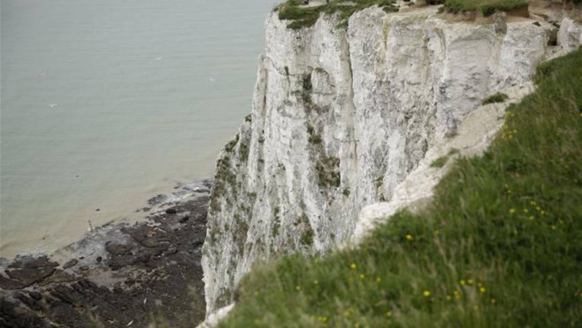 Visitors look down from the top of a section of the White Cliffs of Dover on June 9, 2016.