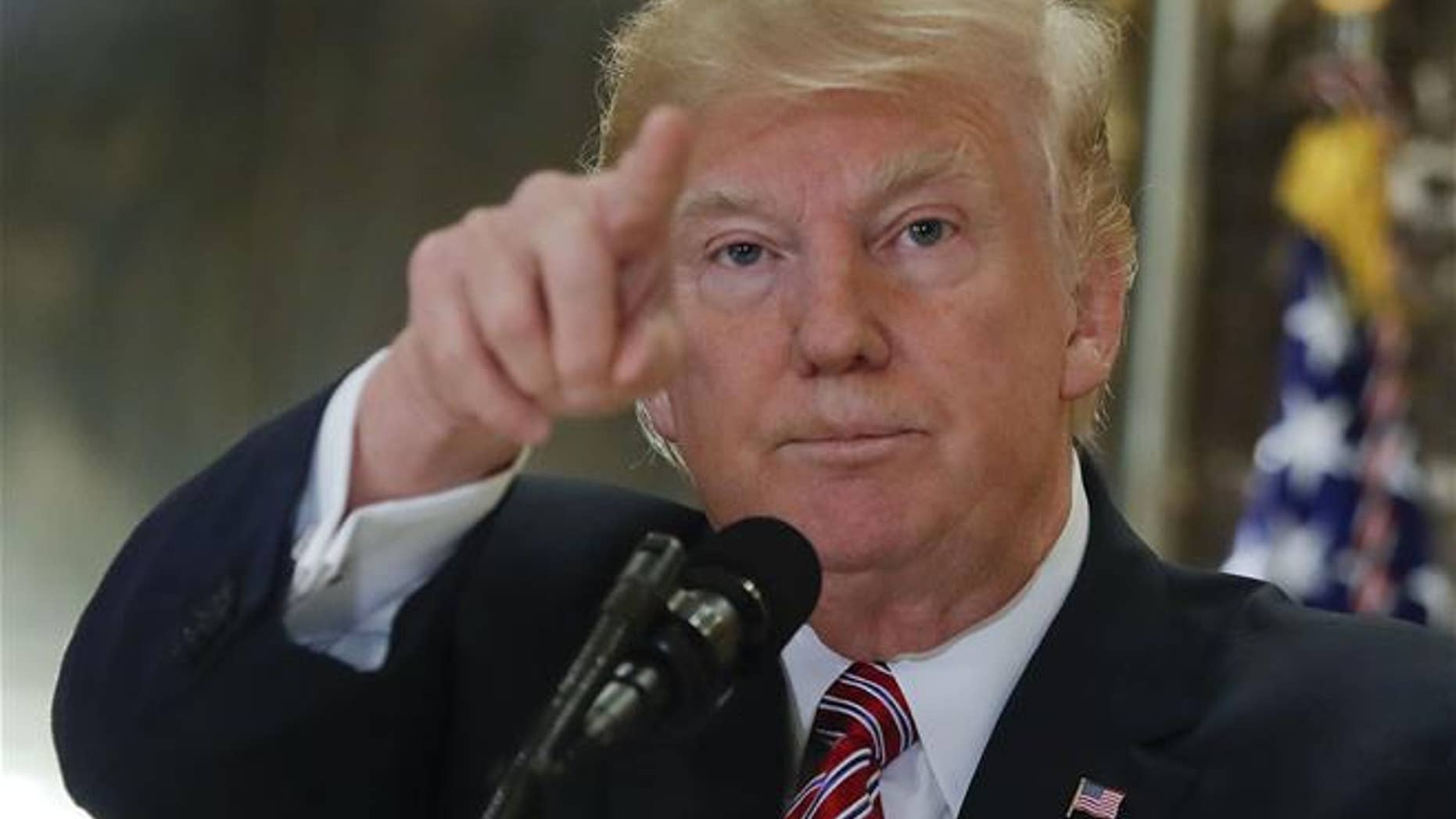 President Trump points to members of the media as he answers questions in the lobby of Trump Tower in New York, Tuesday, Aug. 15, 2017.