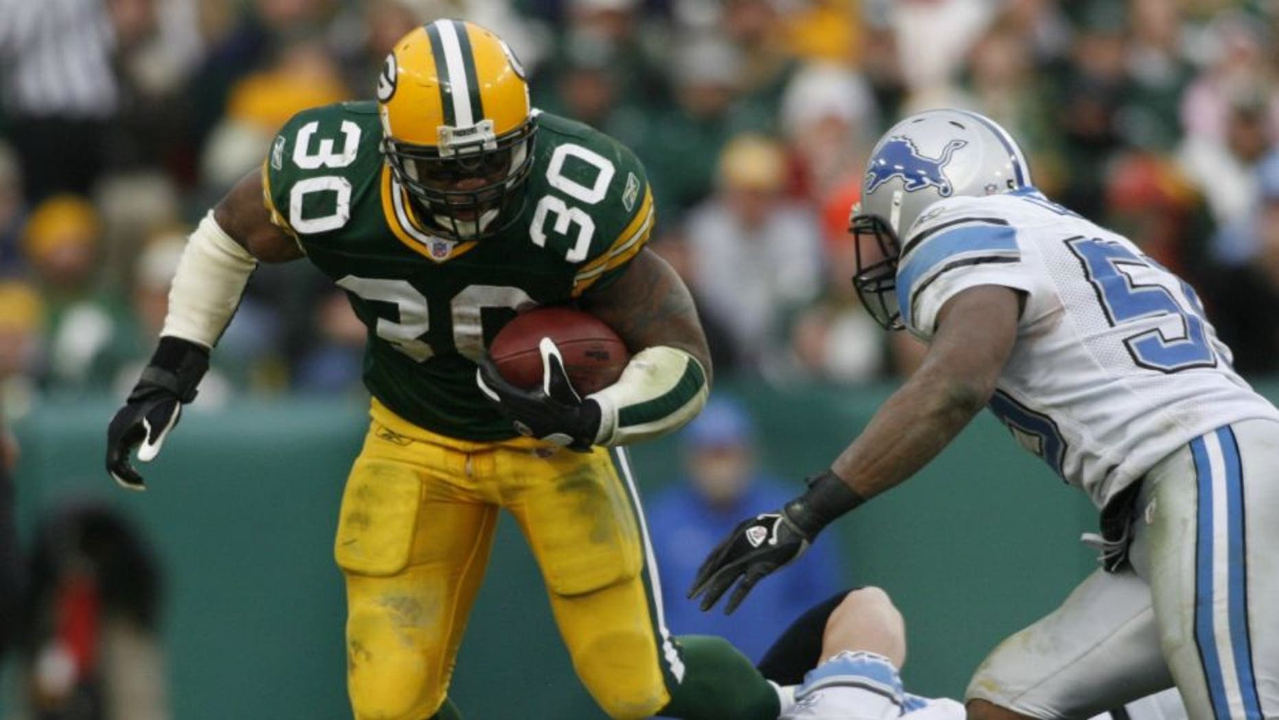 GREEN BAY, WI - DECEMBER 17: Ahman Green #30 of the Green Bay Packers runs through the tackle during a game against the Detroit Lions on December 17, 2006 at Lambeau Field in Green Bay, Wisconsin. (Photo by Sporting News via Getty Images)