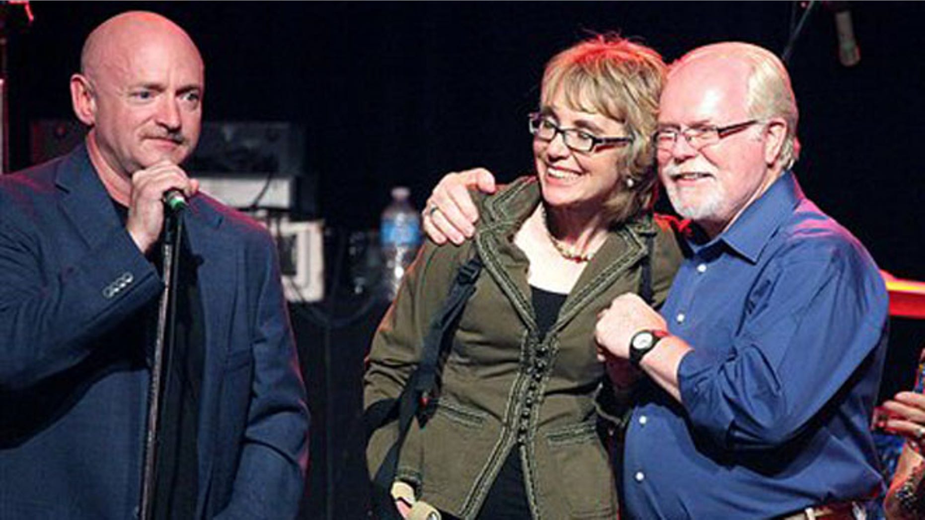 June 9, 2012: From left, Gabrielle Giffords' husband Mark Kelly, Giffords and congressional candidate Ron Barber gather during a get-out-the-vote rally at the Rialto Theater in downtown Tucson, Ariz.