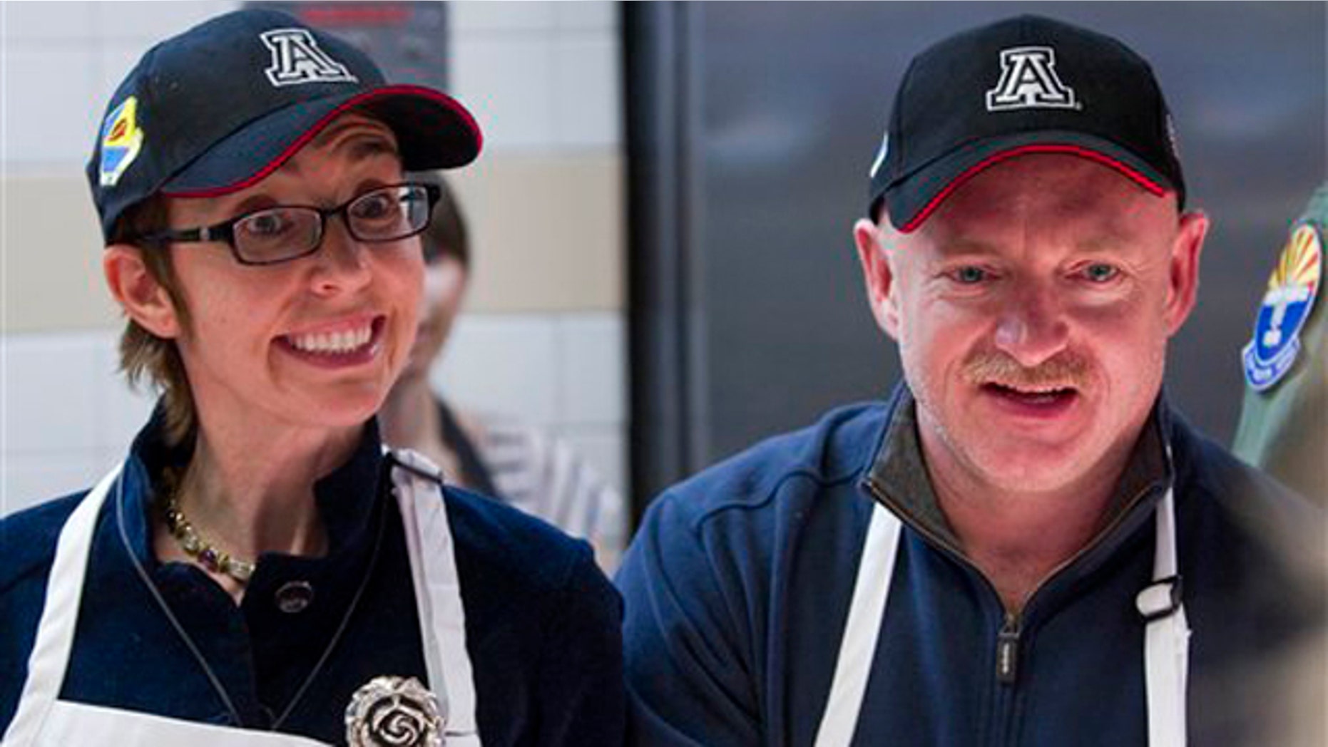 Nov. 24, 2011: Rep Gabrielle Giffords and her husband, retired Capt. Mark Kelly, serve a Thanksgiving meal to troops at Davis-Monthan Air Force Base in Tucson, Ariz.
