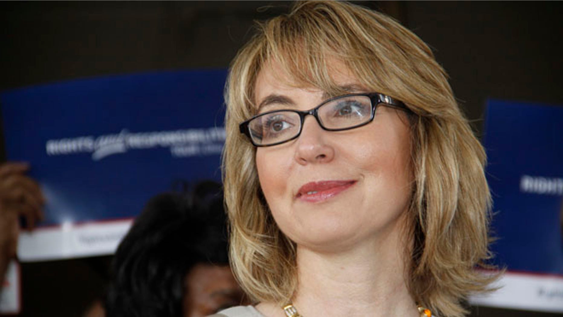 July 4, 2013: Former U.S. Rep. Gabrielle Giffords talks to supporters before she and husband, former astronaut Mark Kelly, take part in a parade in Northside, a suburb of Cincinnati.