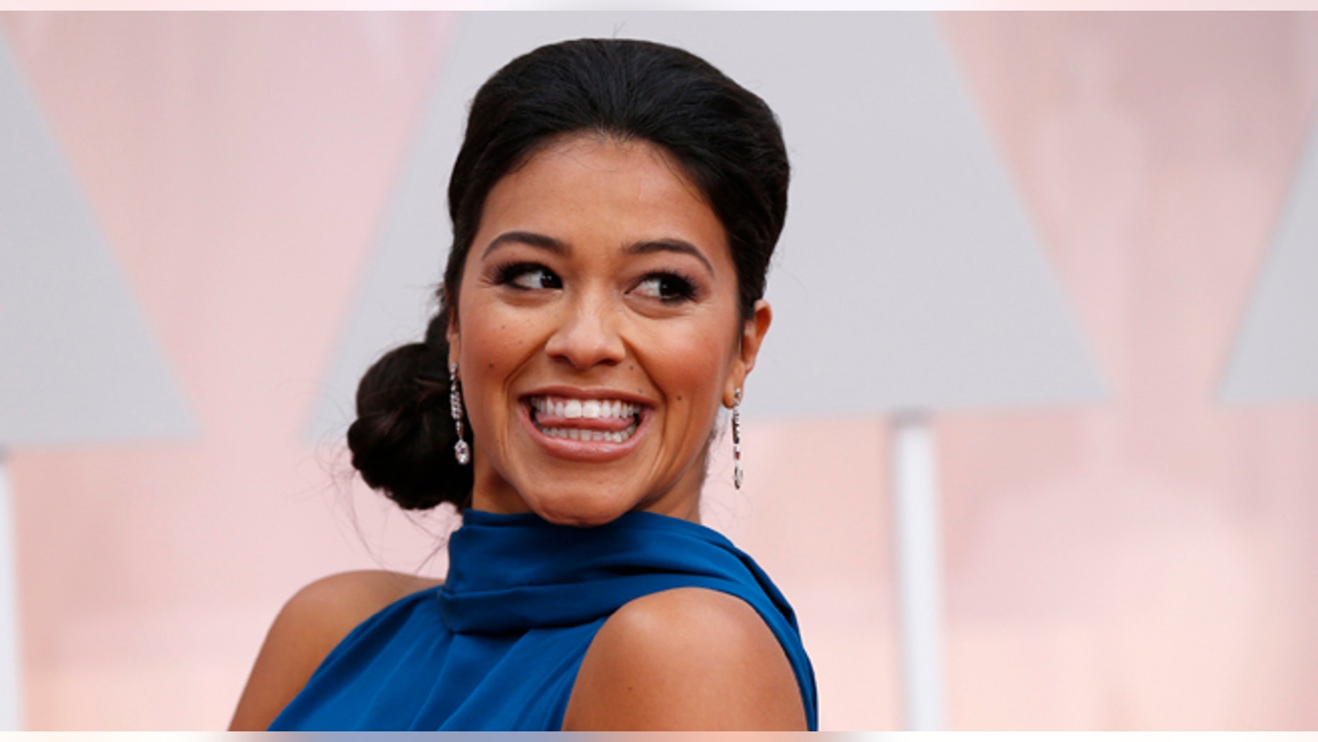 February 22, 2015. Actress Gina Rodriguez, wearing a bright blue Manon Gabard gown, arrives at the 87th Academy Awards in Hollywood, California.
