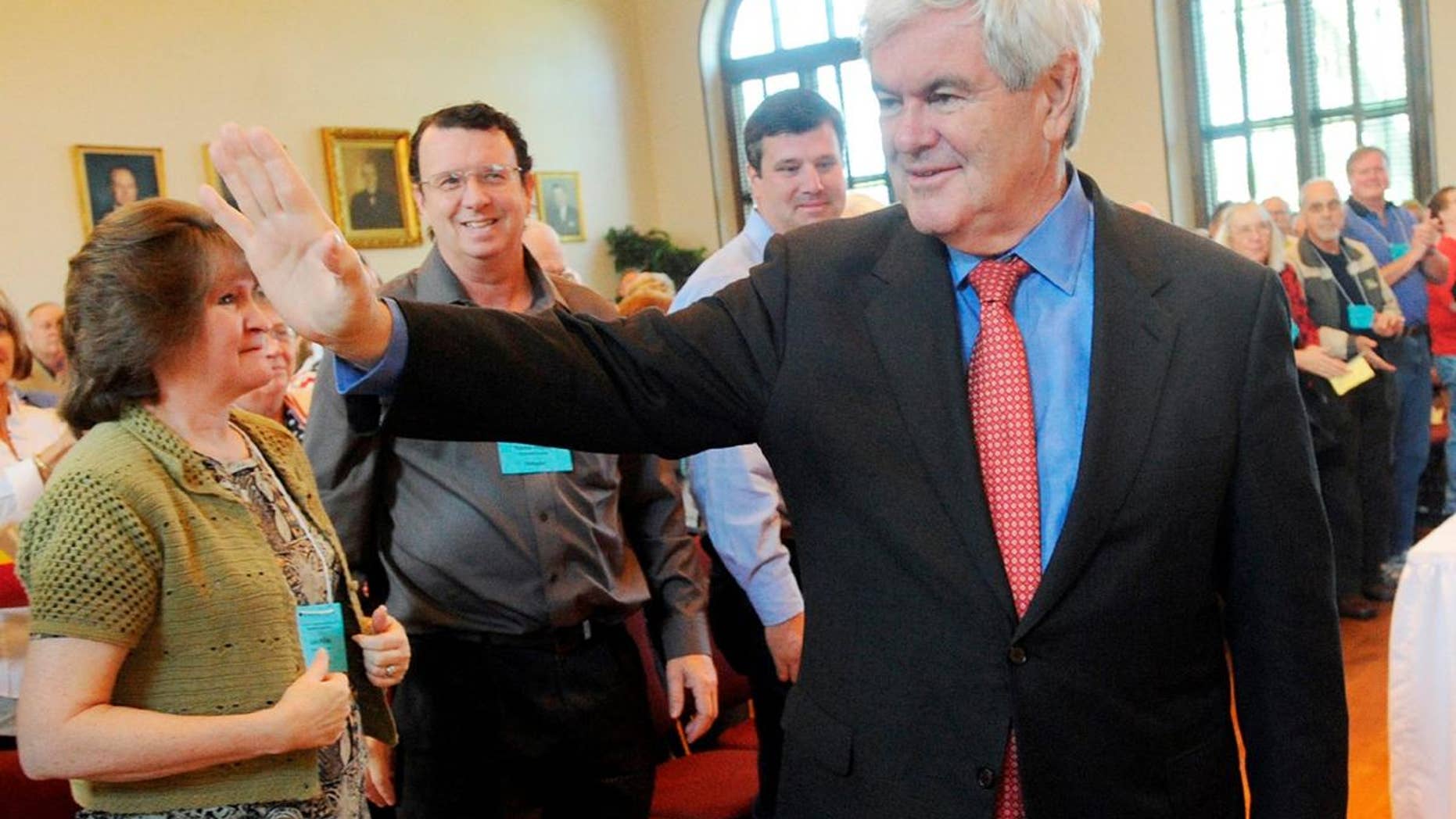 Former Speaker of the House Newt Gingrich is greeted to a standing ovation as he walks into the Historic Courthouse, Saturday, April 16, 2011, in Lawrenceville, Ga. Gingrich spoke during the GOP district convention at the courthouse. (AP Photo/Gwinnett Daily Post, Jonathan Phillips)