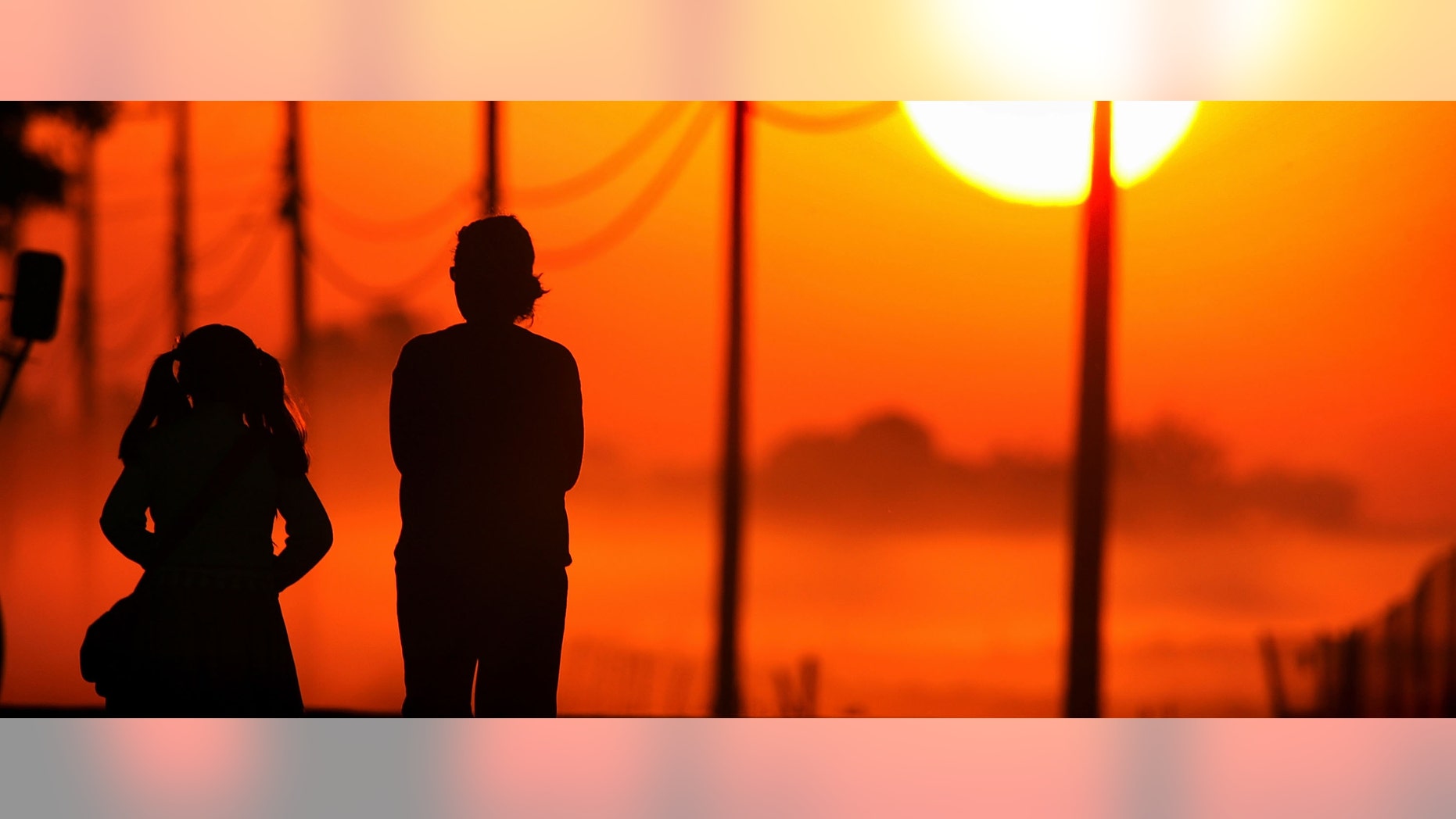 STOCKTON, CA - SEPTEMBER 29: A young girl walks to her school bus stop at sunrise with another person on Bethel Island, one of the residential islands surrounded by levees that hold back the higher waters of the Sacramento-San Joaquin River Delta on September 29, 2005 west of Stockton, California. Officials say that the dikes of the Sacramento-San Joaquin River Delta are in worse shape than those that broke and flooded New Orleans during Hurricane Katrina. There is a two-in-three chance that a catastrophic earthquake or storm in the next 50 years may damage the levees enough to cause the kind of destruction that engulfed New Orleans, according to experts. Such an event would affect the water supply that serves two-thirds of California and create a nightmare traffic jam on Highway 4, the two-lane road that would be the major evacuation route, if it is not damaged beyond usability. Approximately 1,600 miles of levees protect the delta's islands, which lie well below sea-level, and most were built more than 100 years ago. (Photo by David McNew/Getty Images)