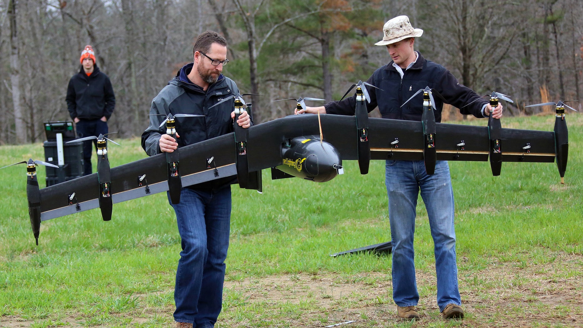 Engineers David North (L) and Bill Fredericks (R) carry the Greased Lightning before one of its flight tests. (NASA Langley/David C. Bowman)